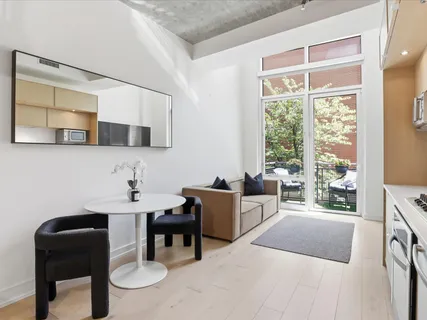 a bedroom with a bed and a chair with the outer view