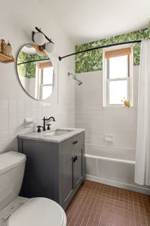 a bathroom with a sink a toilet and a mirror