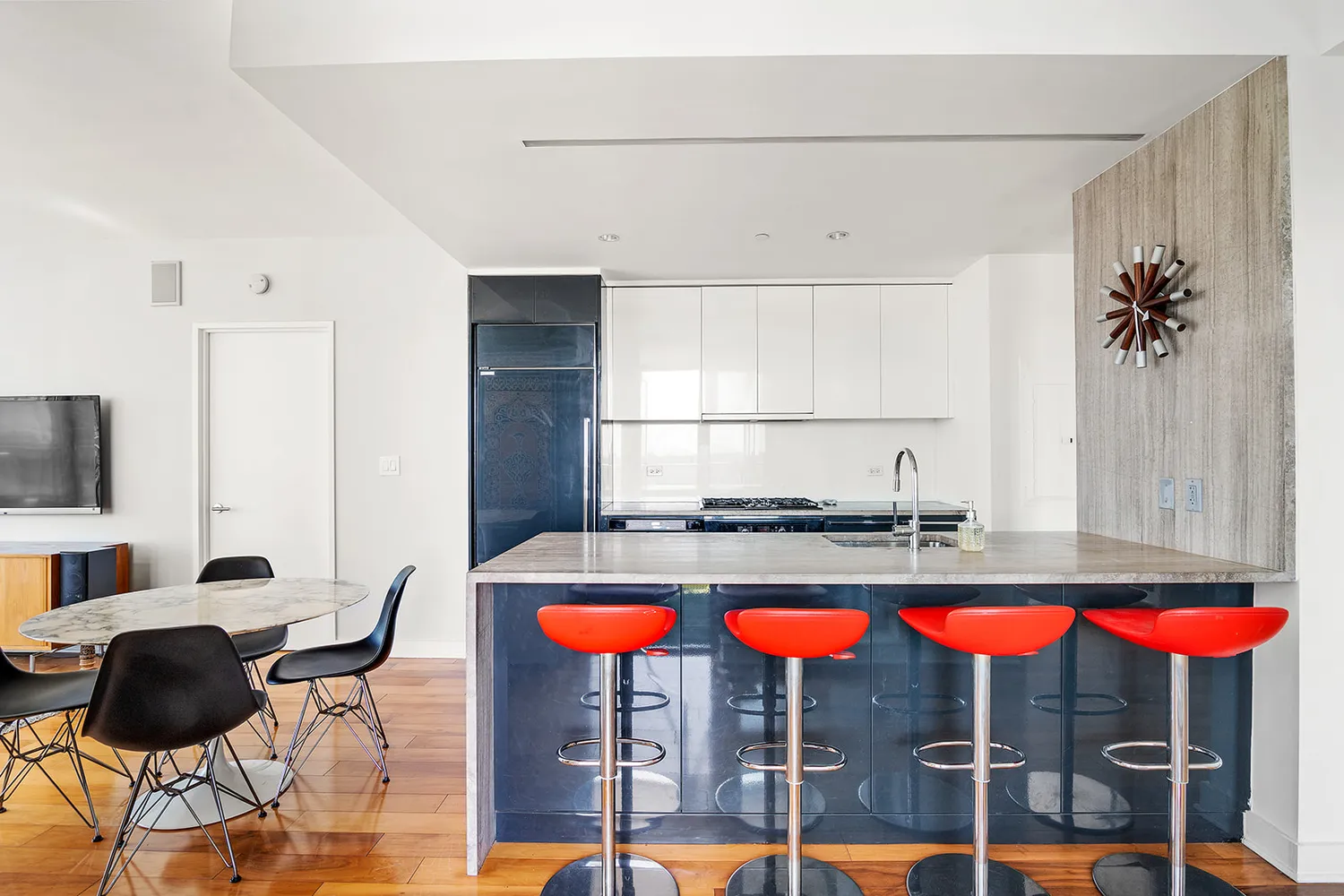 a kitchen with stainless steel appliances kitchen island granite countertop a table and chairs