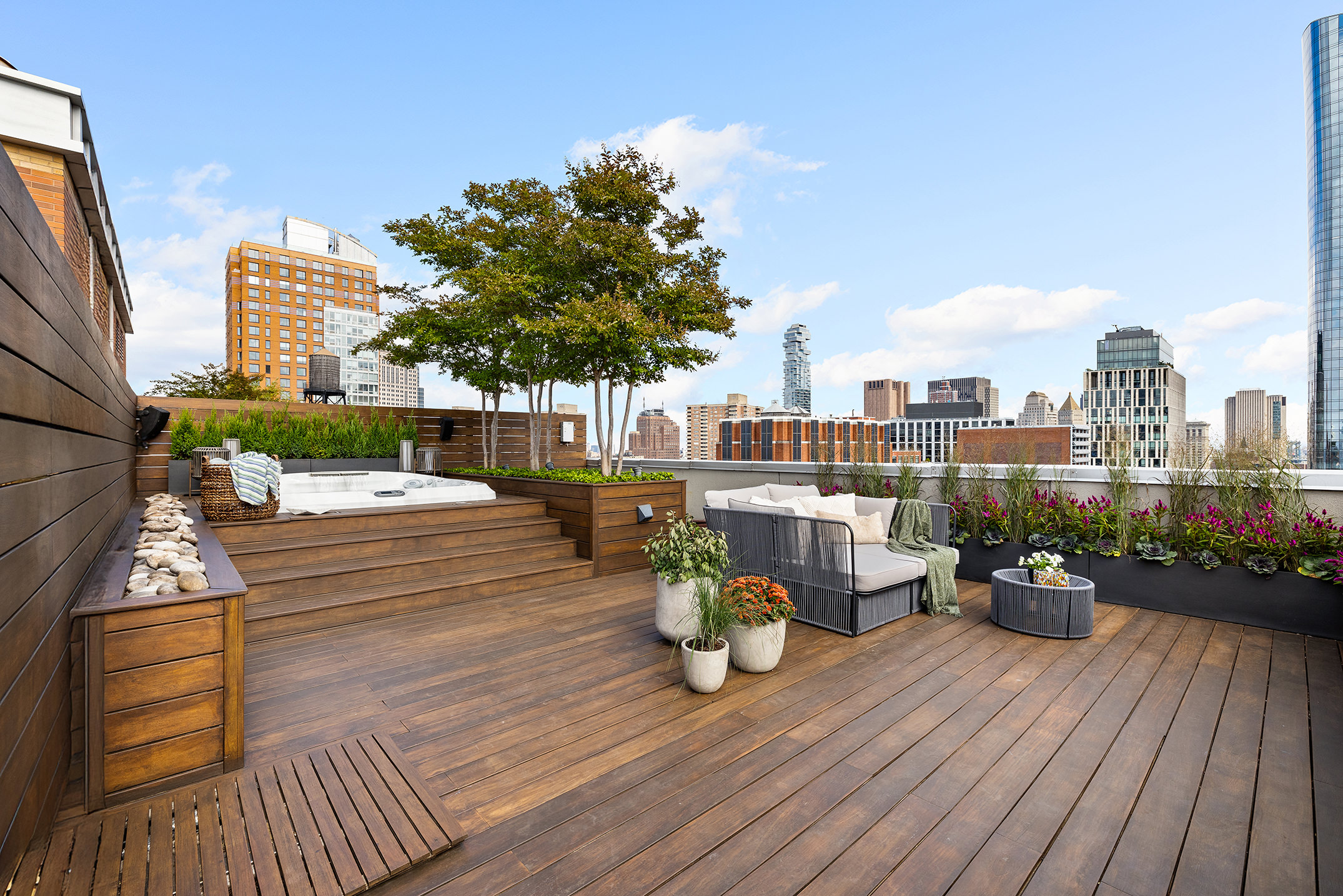212 Warren Street, Unit PHS Manhattan, NY 10282 - Photo 13 of 18 a view of roof deck with dining table and chairs couches with wooden floor