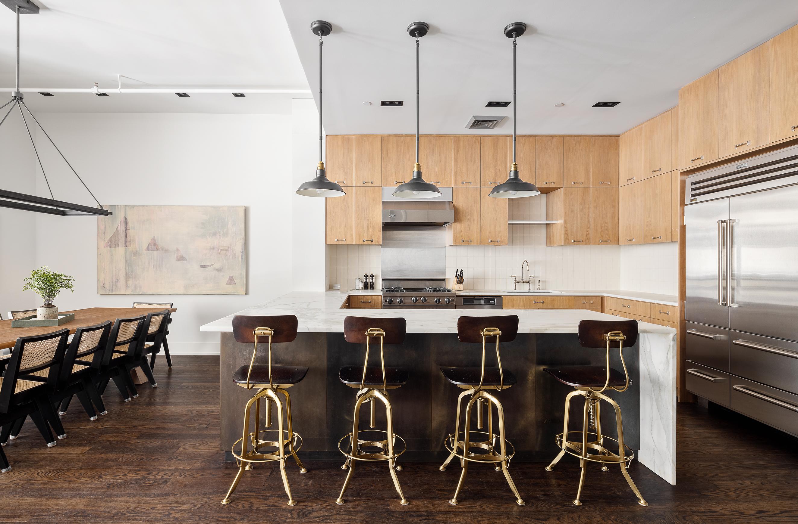 20 Greene Street, Unit 4B Manhattan, NY 10013 - Photo 2 of 13 a open kitchen with stainless steel appliances granite countertop a dining table chairs and white cabinets