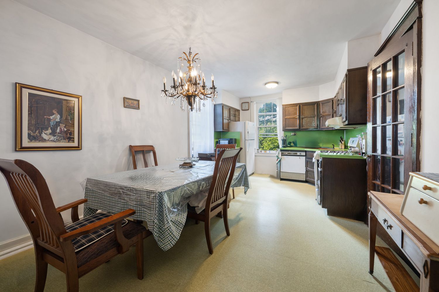 a dining room with furniture and a kitchen view