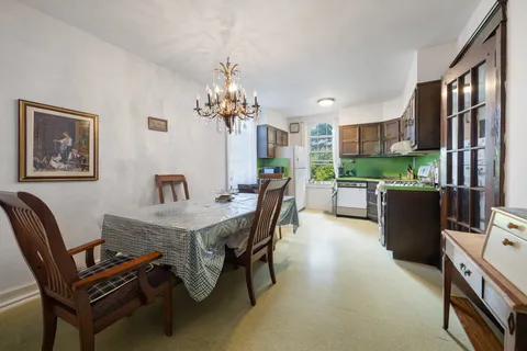 a dining room with furniture and a kitchen view