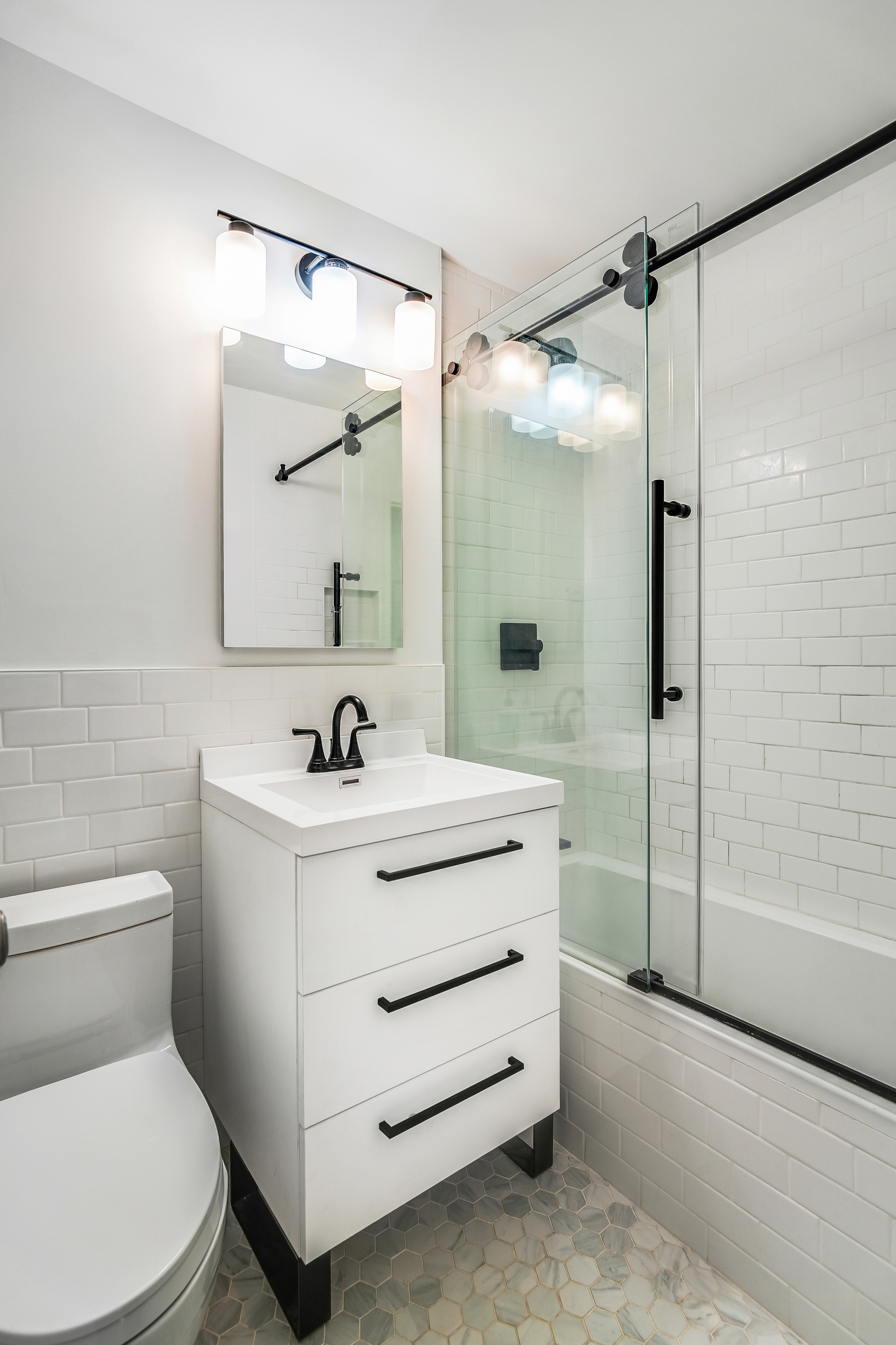 301 East 69th Street, Unit 3M Manhattan, NY 10021 - Photo 7 of 12 a bathroom with a sink toilet and shower