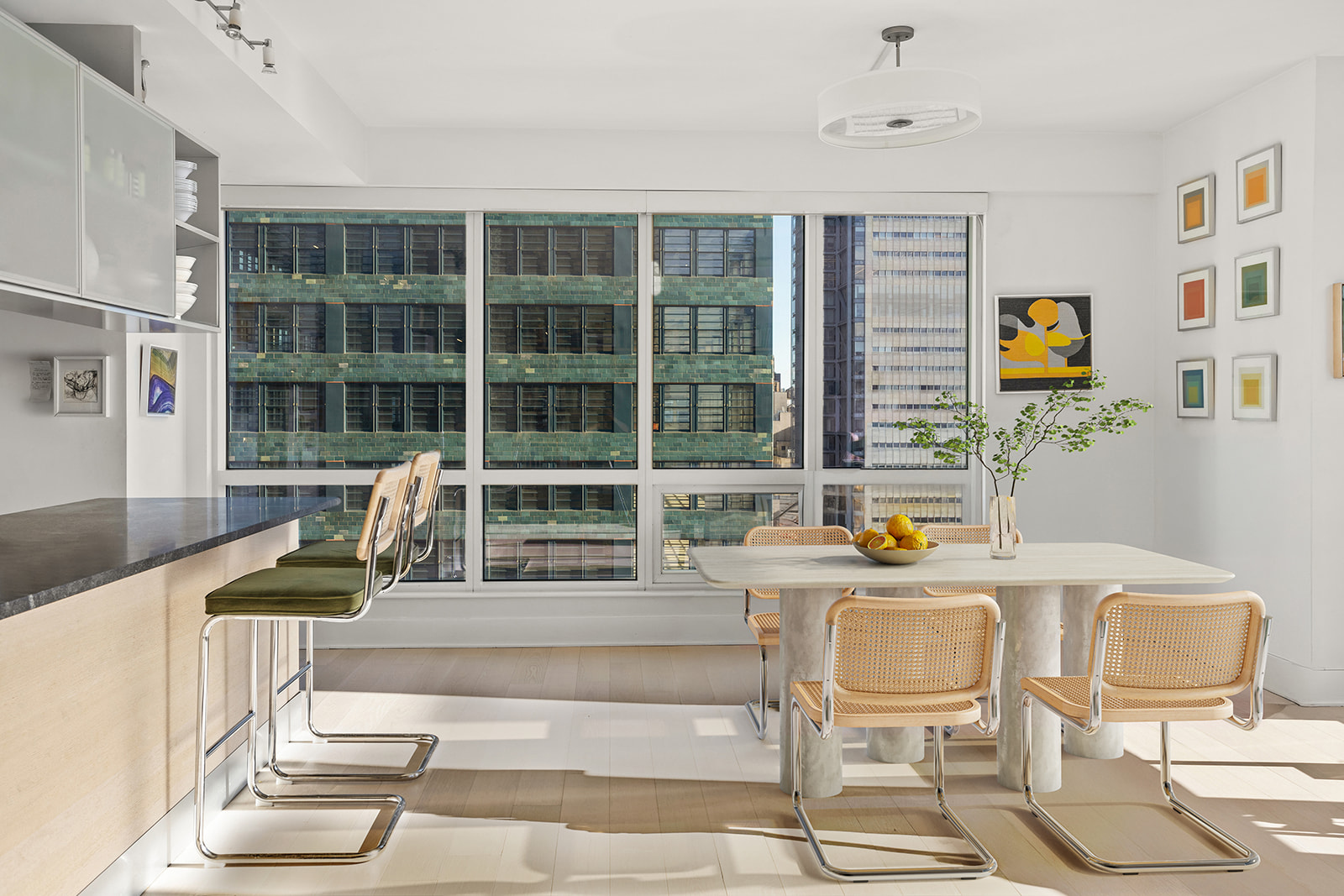 350 West 42nd Street, Unit 33G Manhattan, NY 10036 - Photo 5 of 20 a view of a dining room with furniture a chandelier and wooden floor