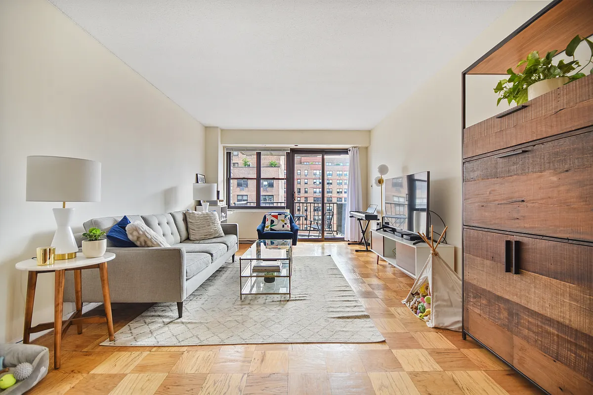 345 East 80th Street, Unit 17J Manhattan, NY 10075 - Photo 1 of 8 a living room with furniture and a window
