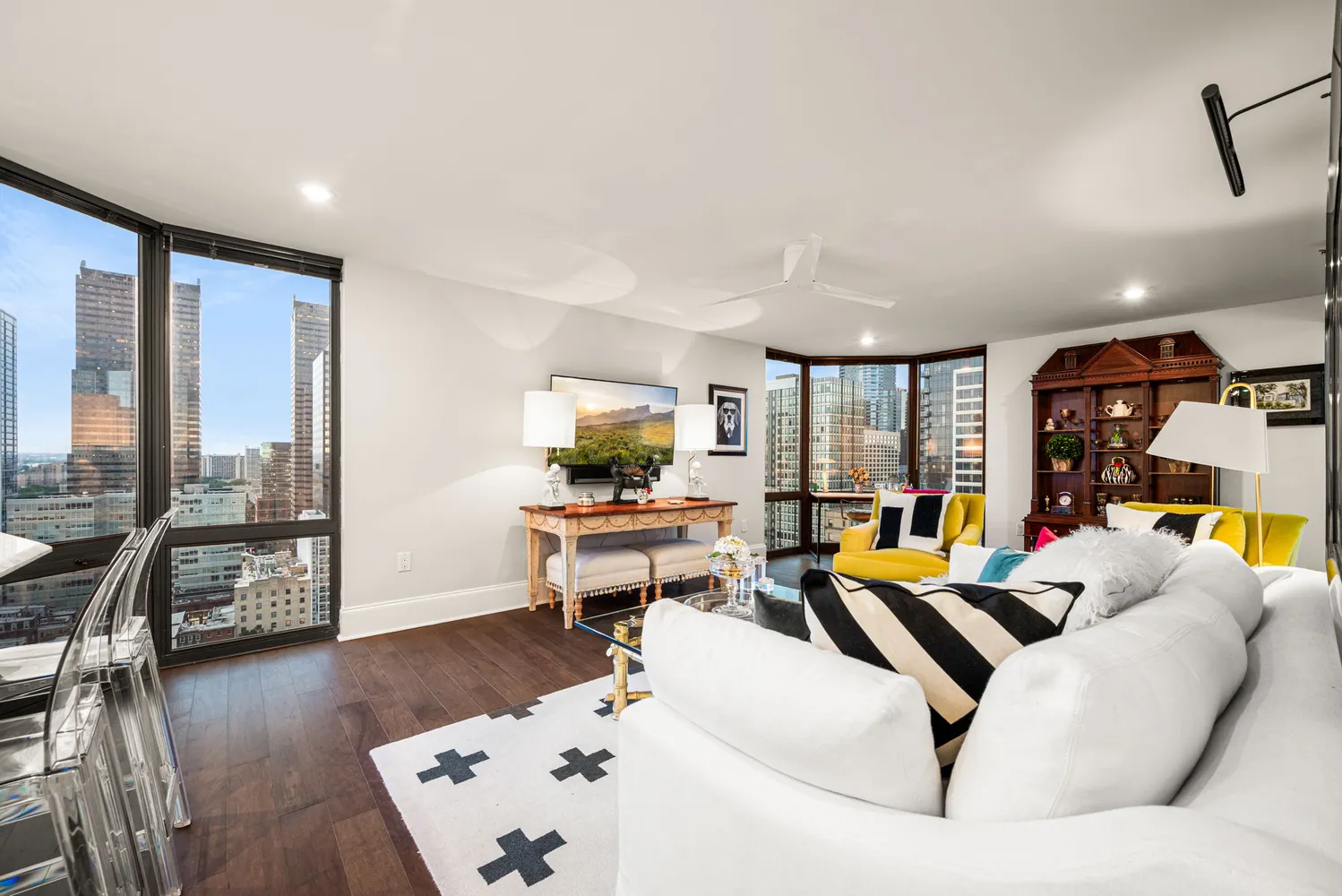 a living room with furniture and wooden floor