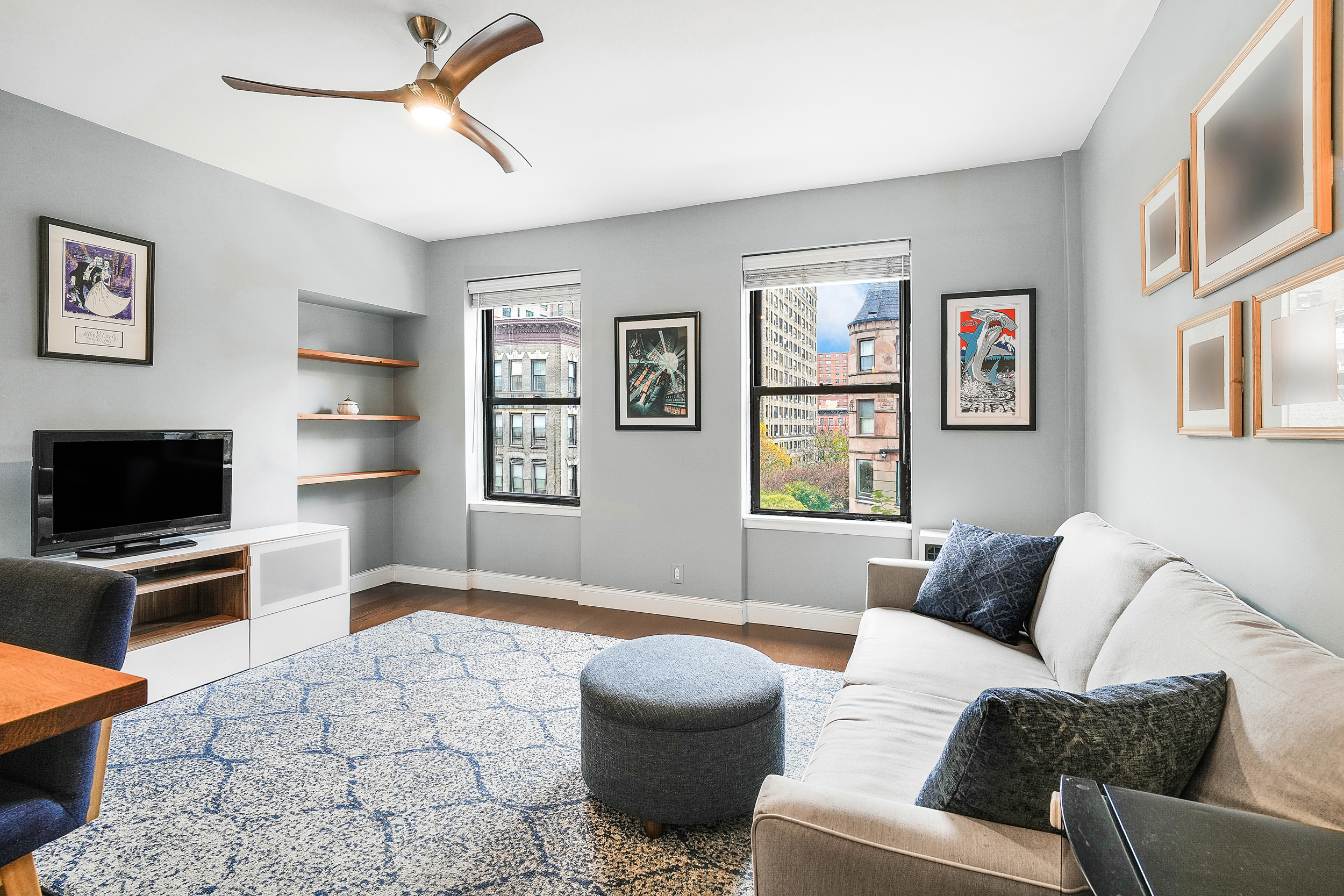 855 West End Avenue, Unit 4B Manhattan, NY 10025 - Photo 2 of 13 a living room with furniture a flat screen tv and a couch