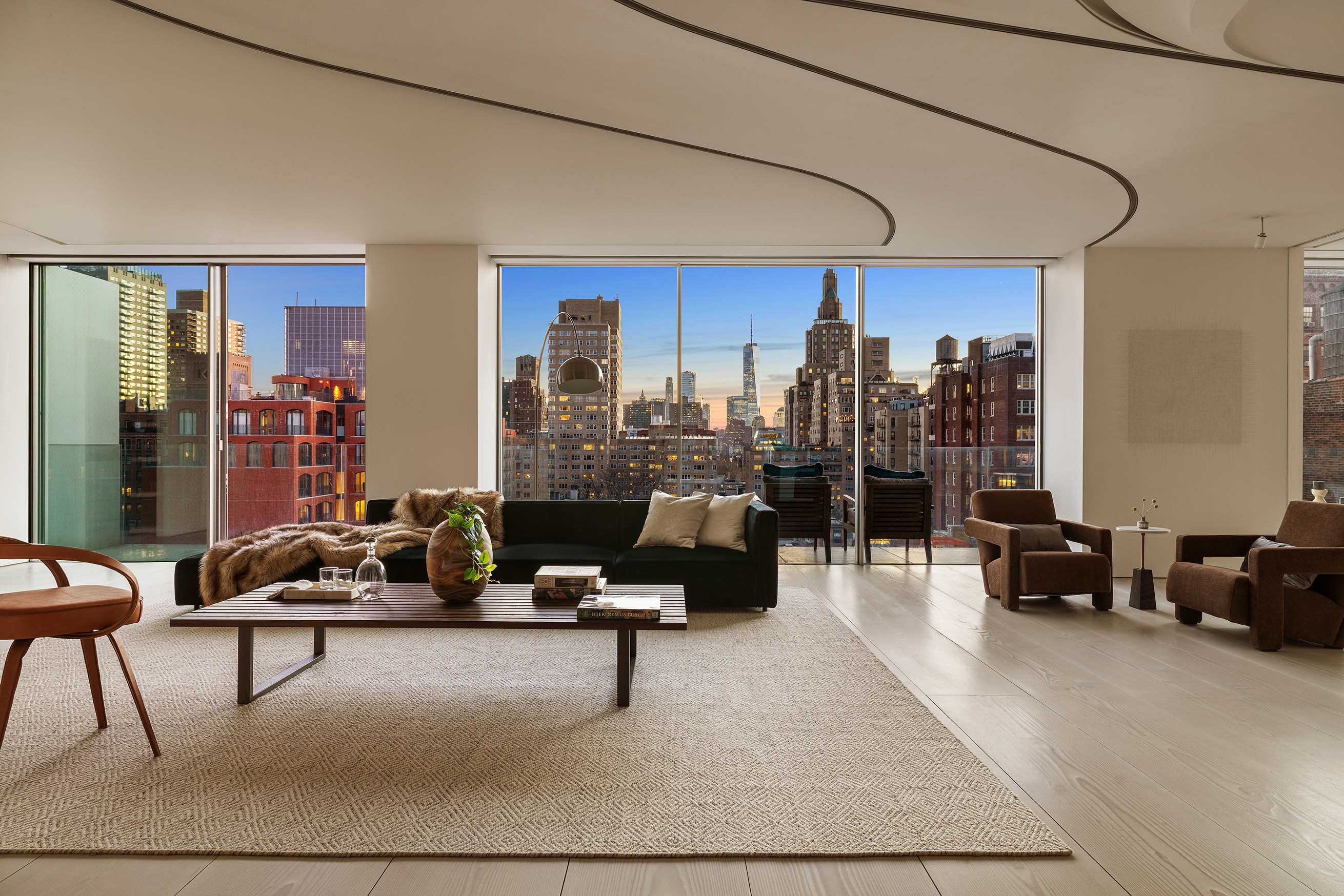 12 East 12th Street, Unit 9NS Manhattan, NY 10003 - Photo 1 of 21 a living room with furniture and a large window
