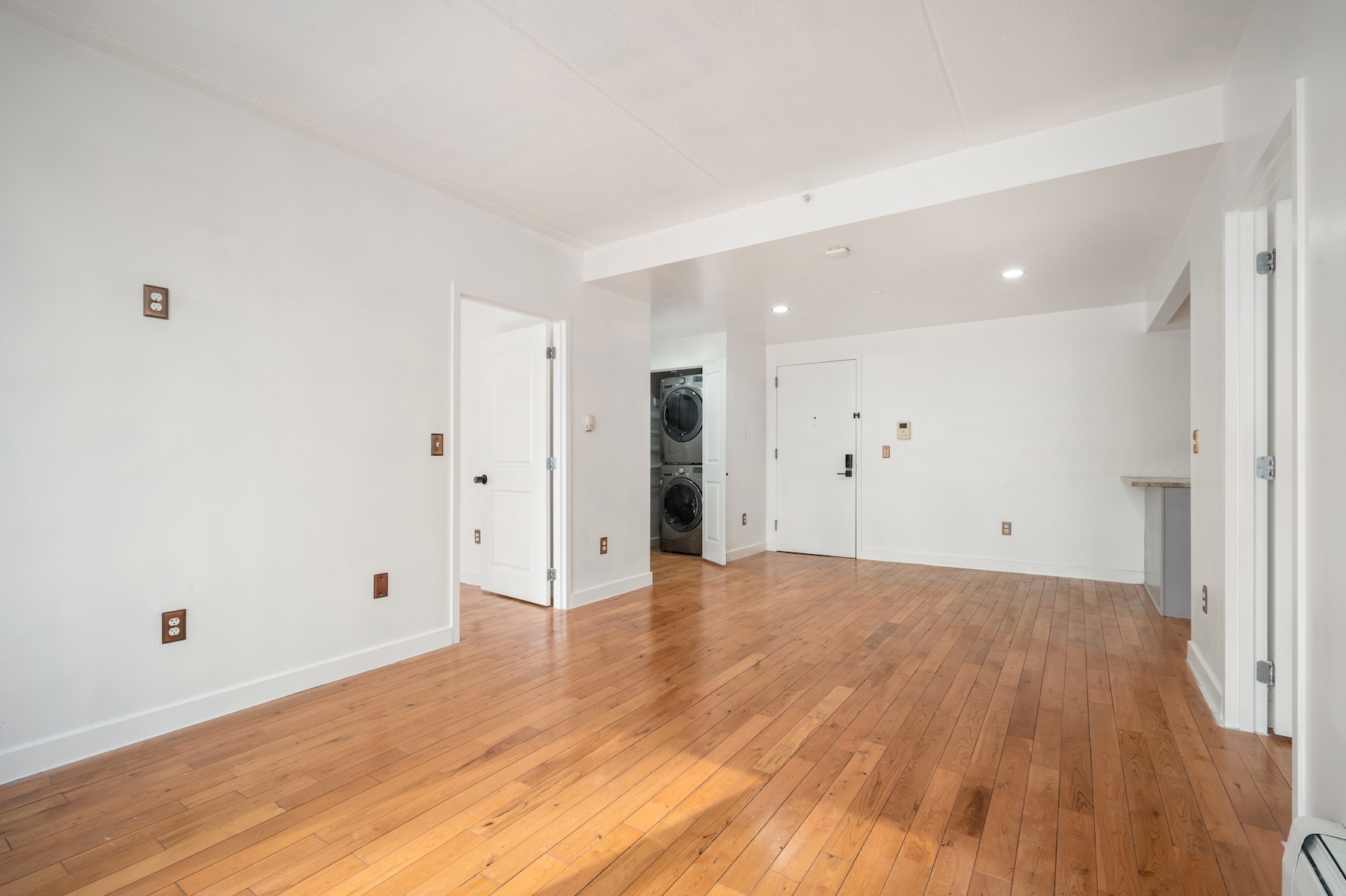 29 West 138th Street, Unit 2D Manhattan, NY 10037 - Photo 6 of 10 a view of an empty room with wooden floor