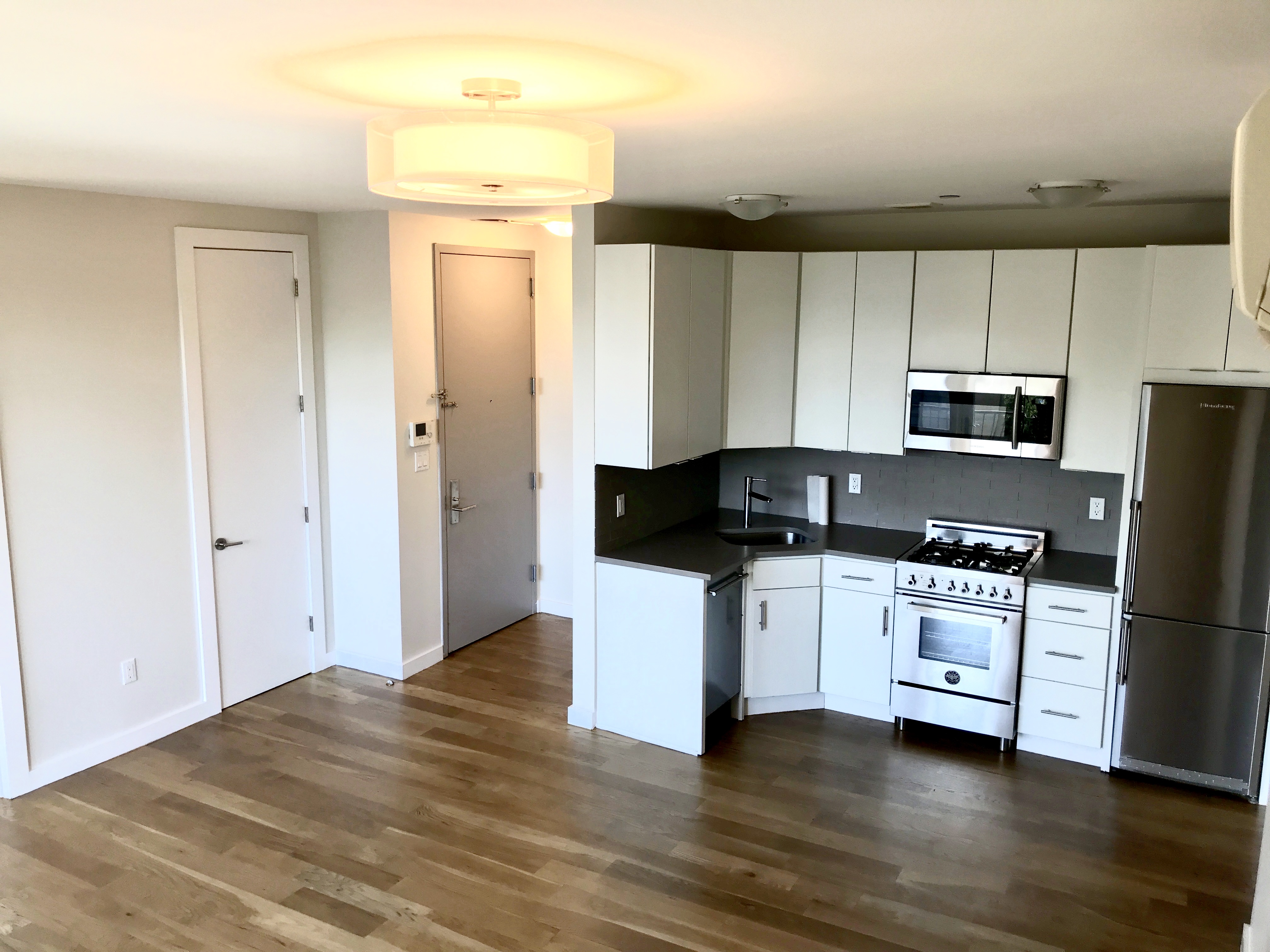1149 Bedford Avenue, Unit 4A Brooklyn, NY 11216 - Photo 2 of 9 a kitchen with a refrigerator and a stove top oven