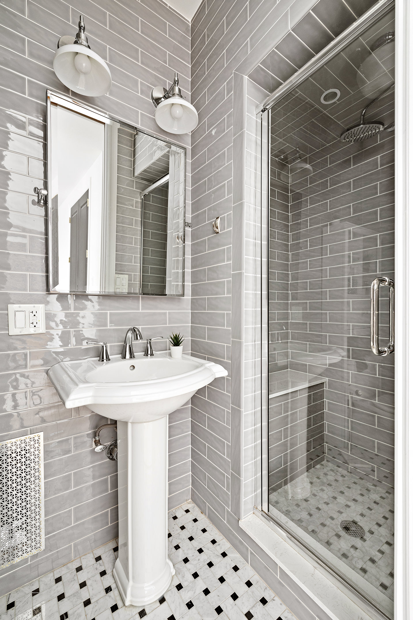 163 Ocean Avenue, Unit G6 Brooklyn, NY 11225 - Photo 9 of 12 a bathroom with a sink a mirror and shower