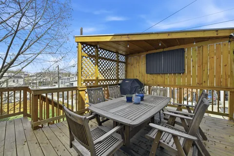 a view of a deck with wooden floor and outdoor seating