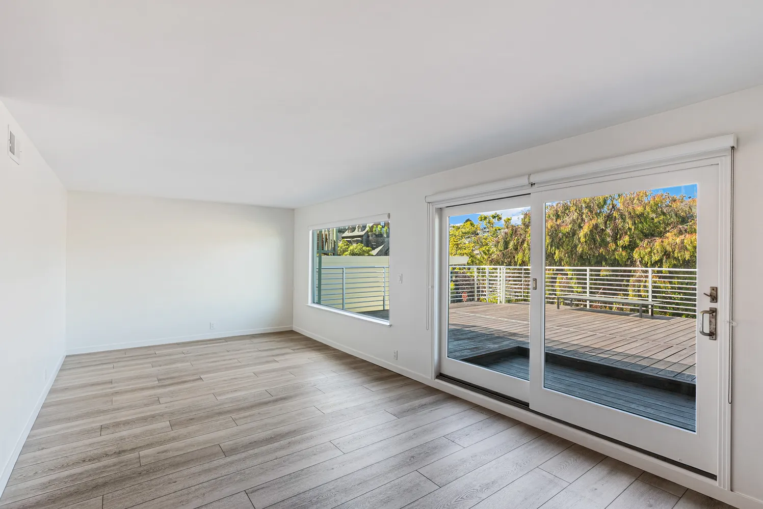 a view of a room with wooden floor and windows