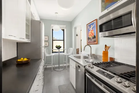 a kitchen with stainless steel appliances granite countertop a stove and a sink