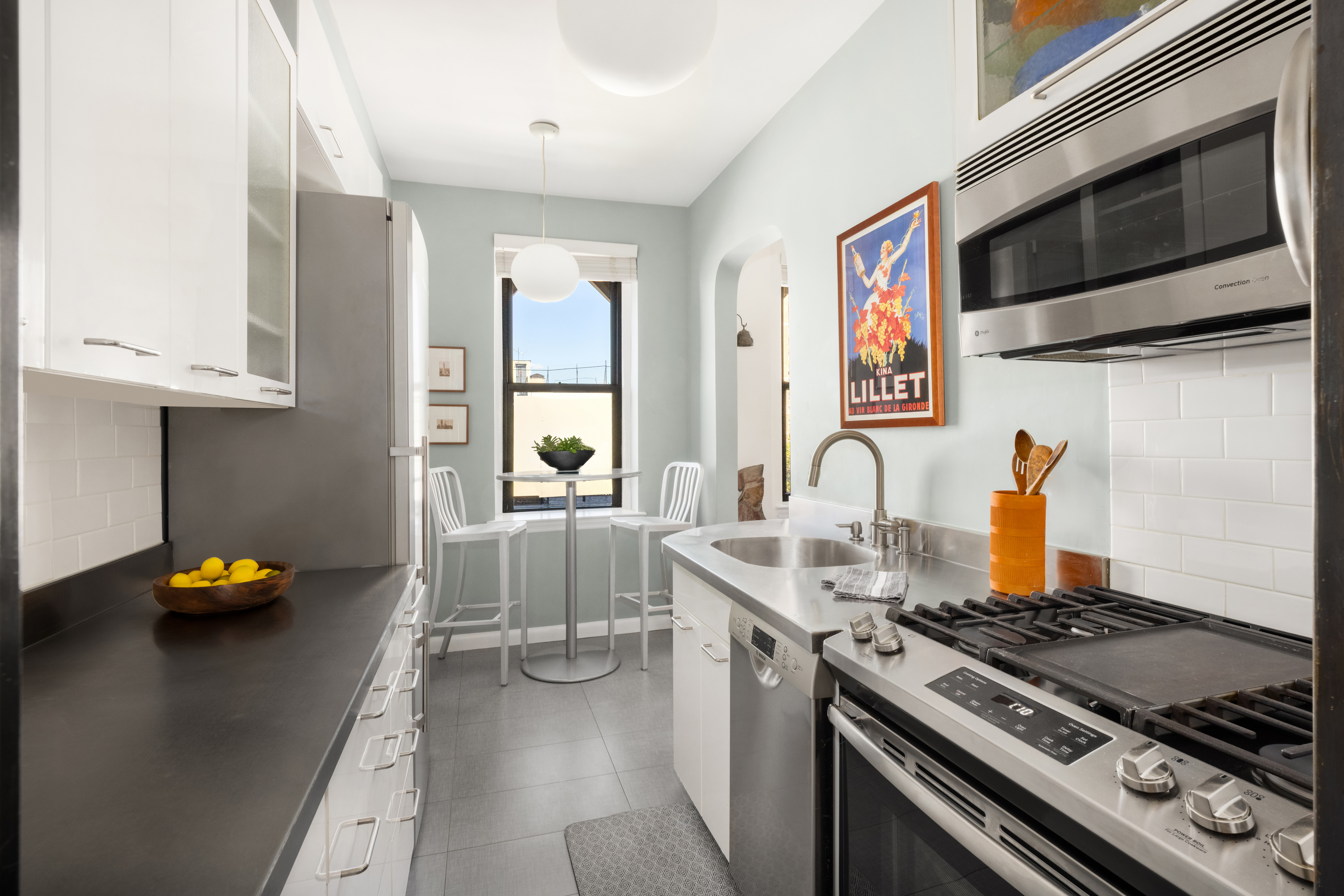 87 East 2nd Street, Unit 5C Manhattan, NY 10003 - Photo 4 of 9 a kitchen with stainless steel appliances granite countertop a stove and a sink