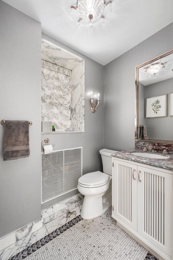 a bathroom with a toilet sink and mirror