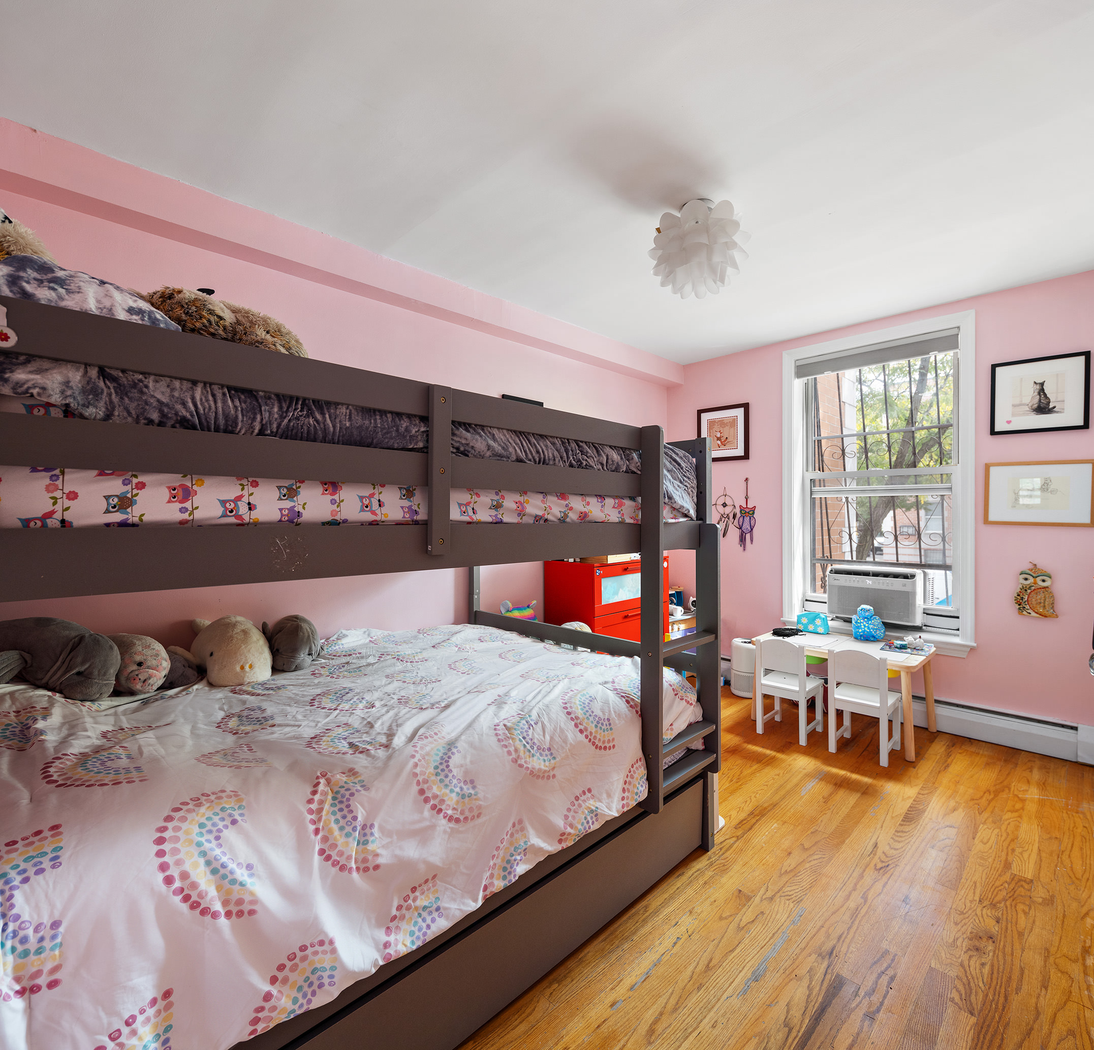 2551 Frederick Douglass Boulevard, Unit B Manhattan, NY 10030 - Photo 7 of 9 a bedroom with a bed and wooden floor