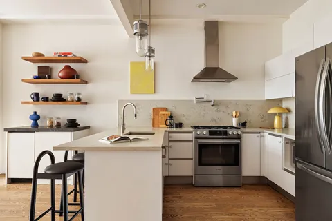 a kitchen with stainless steel appliances granite countertop a sink a stove and refrigerator