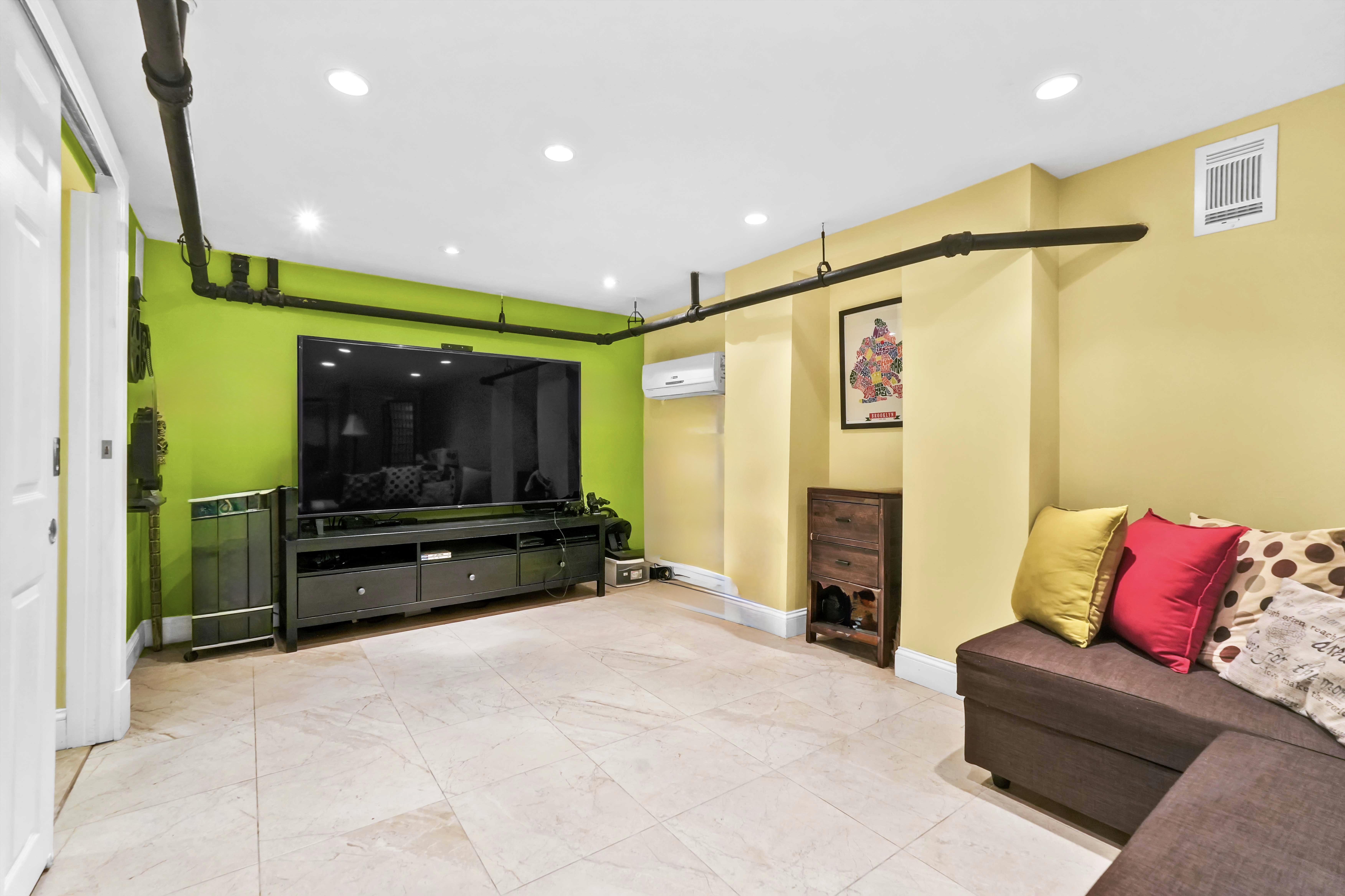 519 Monroe Street Brooklyn, NY 11221 - Photo 48 of 55 a living room with furniture and a flat screen tv