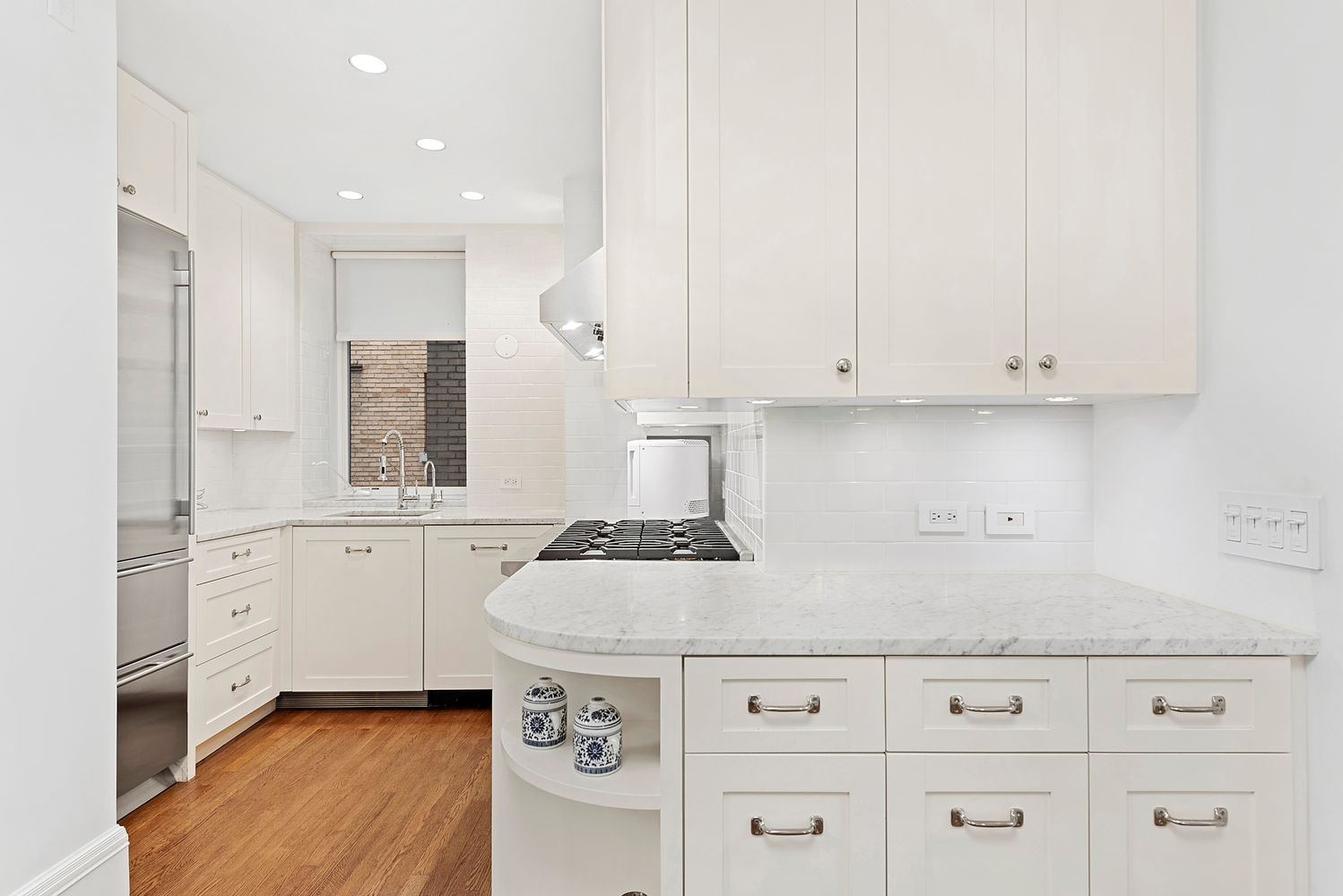 a kitchen with granite countertop white cabinets and white appliances