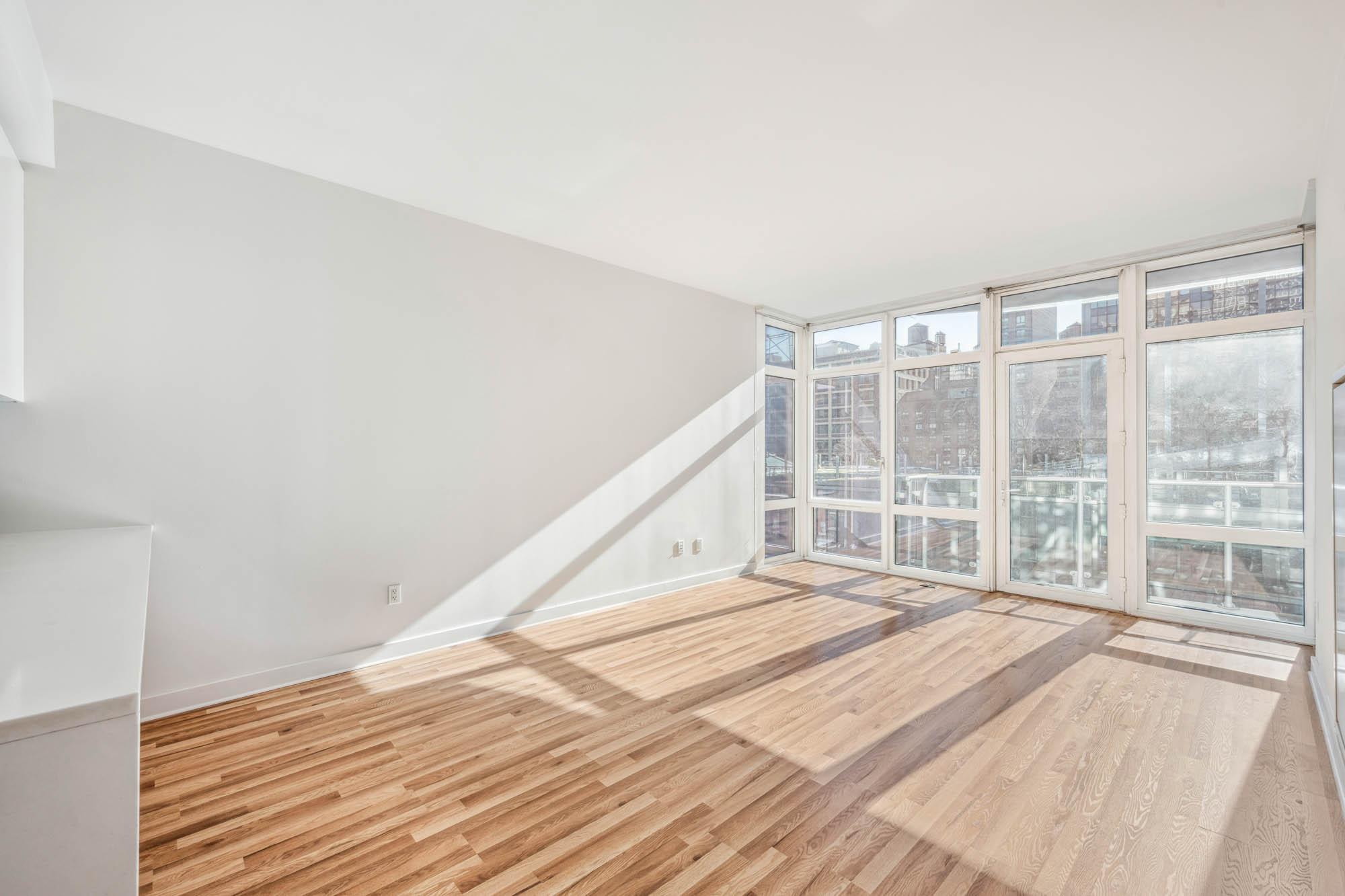 555 West 59th Street, Unit 7E Manhattan, NY 10019 - Photo 2 of 9 a bedroom with a bed and a large window