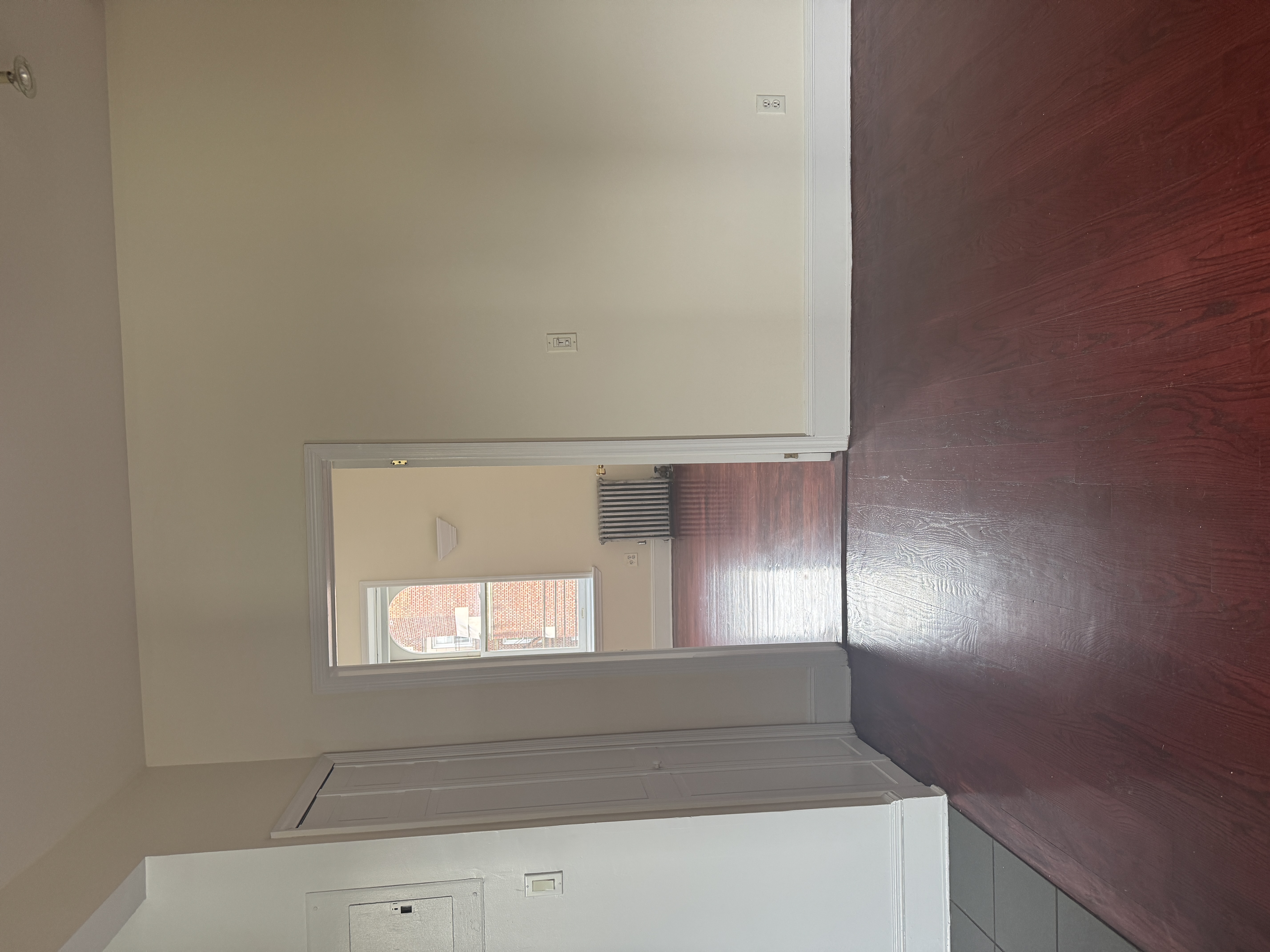 260 Cumberland Street, Unit 21 Brooklyn, NY 11205 - Photo 4 of 13 an empty room with wooden floor and windows