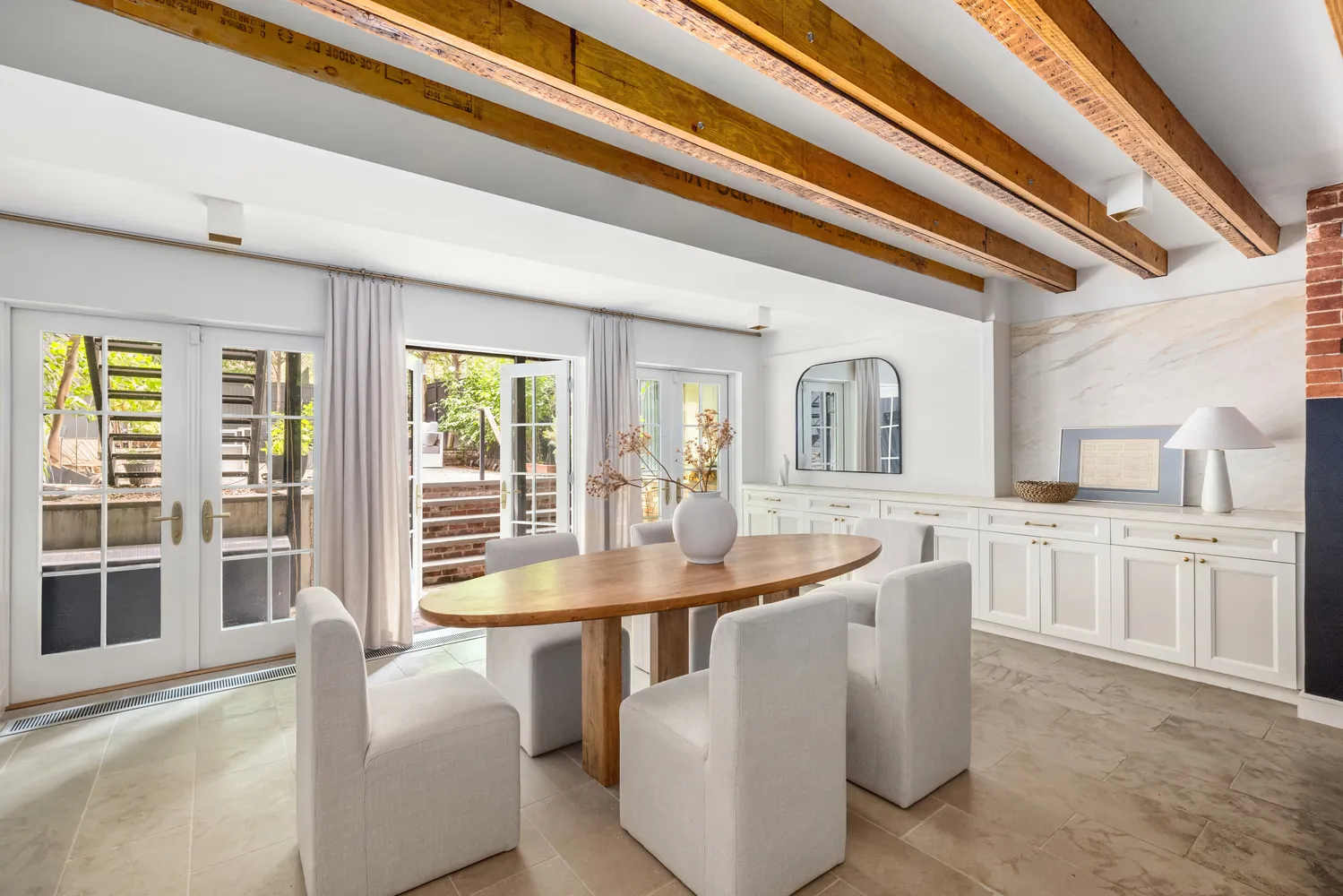 a dining hall with stainless steel appliances granite countertop a sink and dishwasher with a dining table