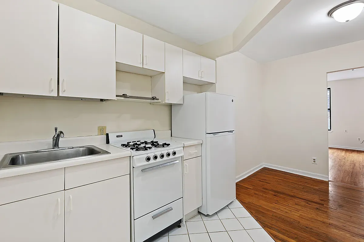 107 East 2nd Street, Unit 11 Manhattan, NY 10009 - Photo 3 of 7 a kitchen with cabinets and appliances