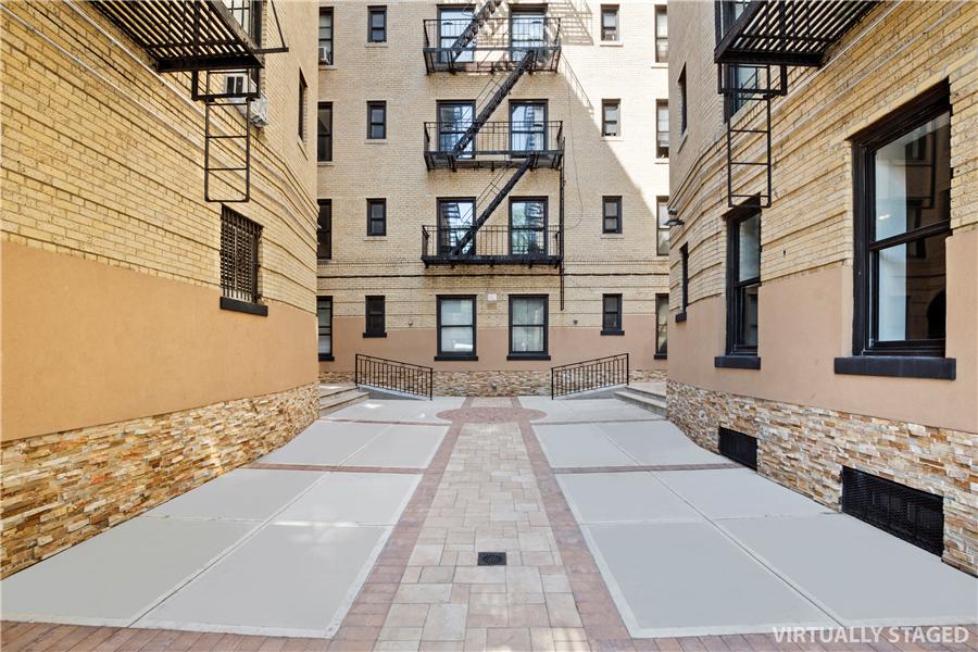 61-09 39th Avenue, Unit 2H Queens, NY 11377 - Photo 7 of 9 a view of a white building