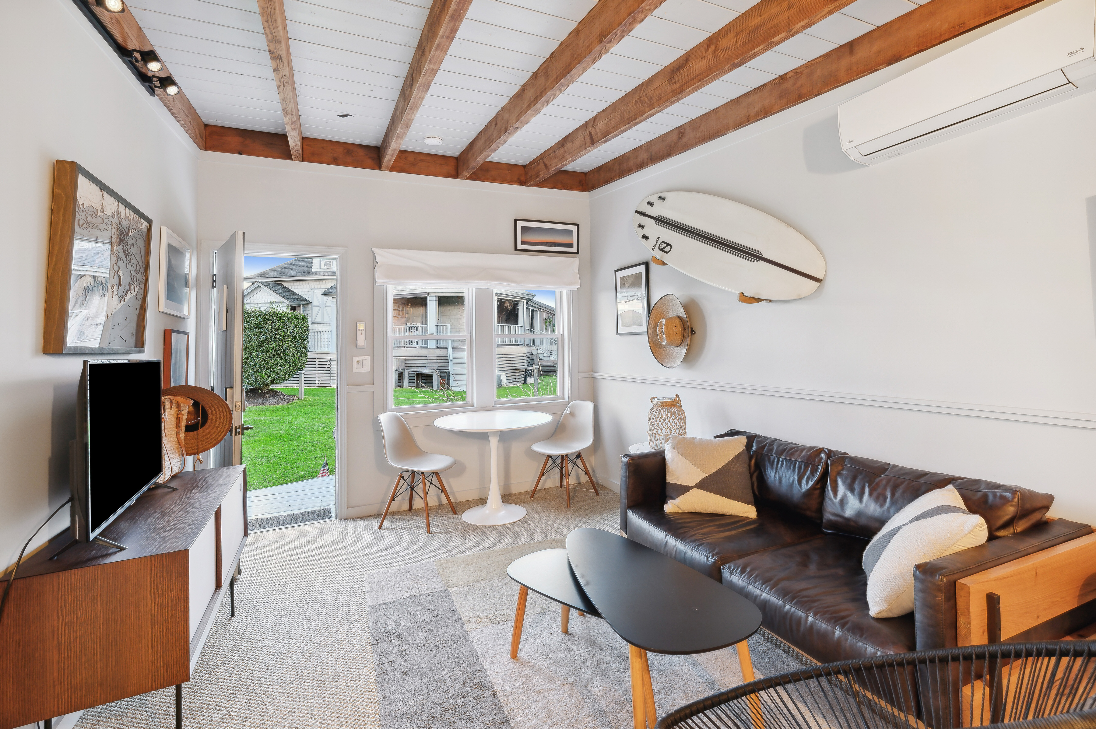 32 Lighthouse Road Hampton Bays, NY 11946 - Photo 43 of 51 a living room with furniture and a flat screen tv