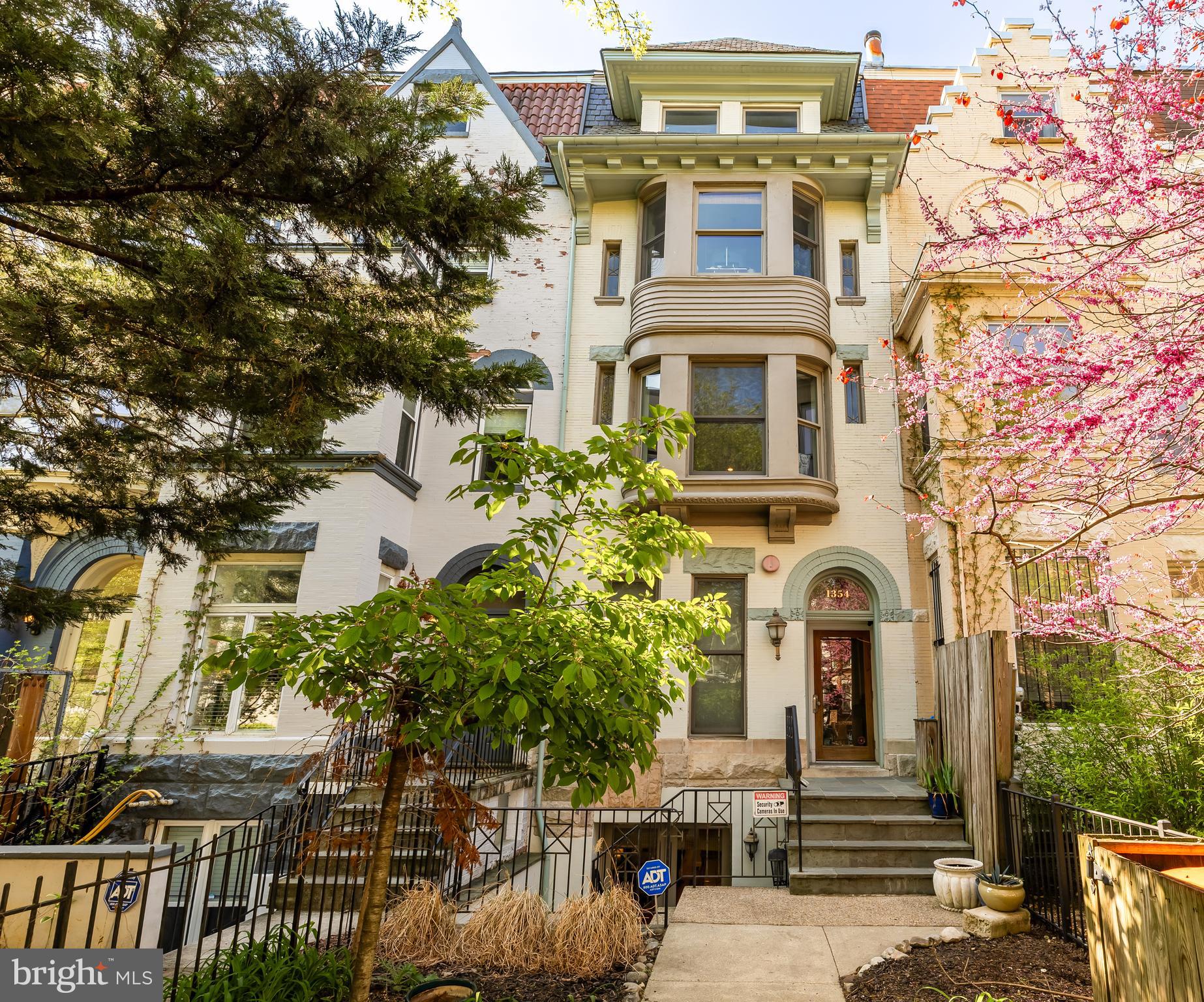 1354 Kenyon Street Northwest, Unit G Washington, DC 20010 - Photo 2 of 37 a front view of a house with a yard