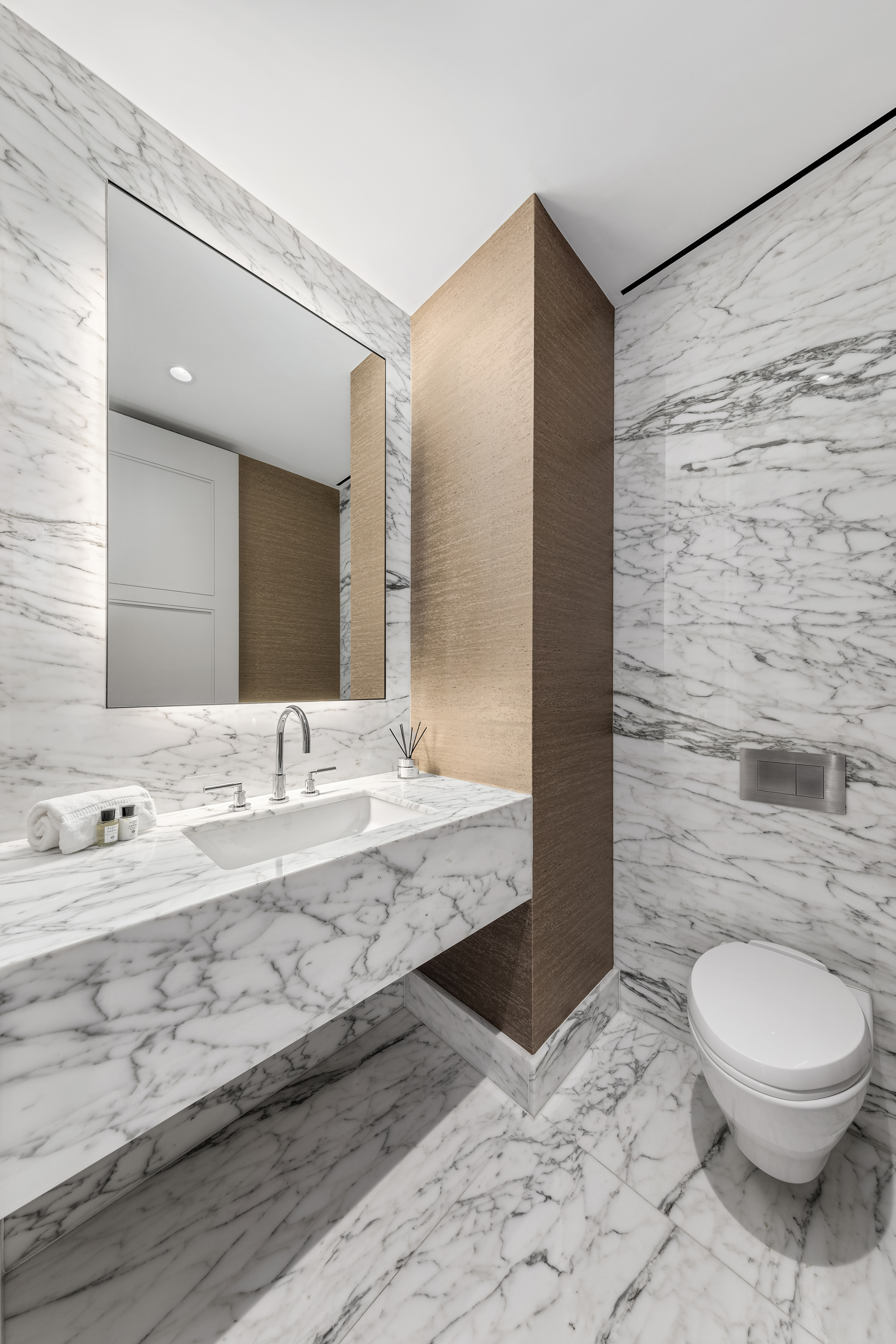 432 Park Avenue, Unit 55A Manhattan, NY 10022 - Photo 12 of 13 a bathroom with a granite countertop sink a toilet and a mirror