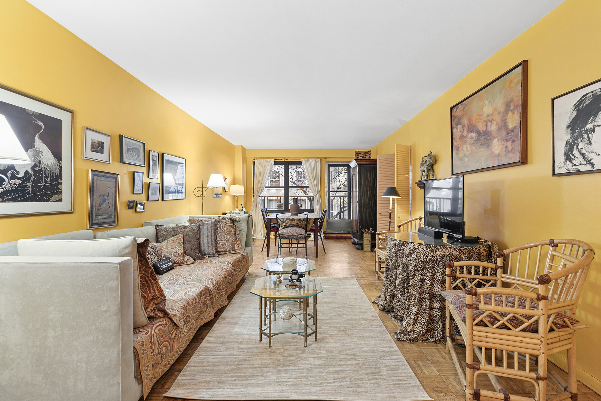 a living room with furniture and a floor to ceiling window