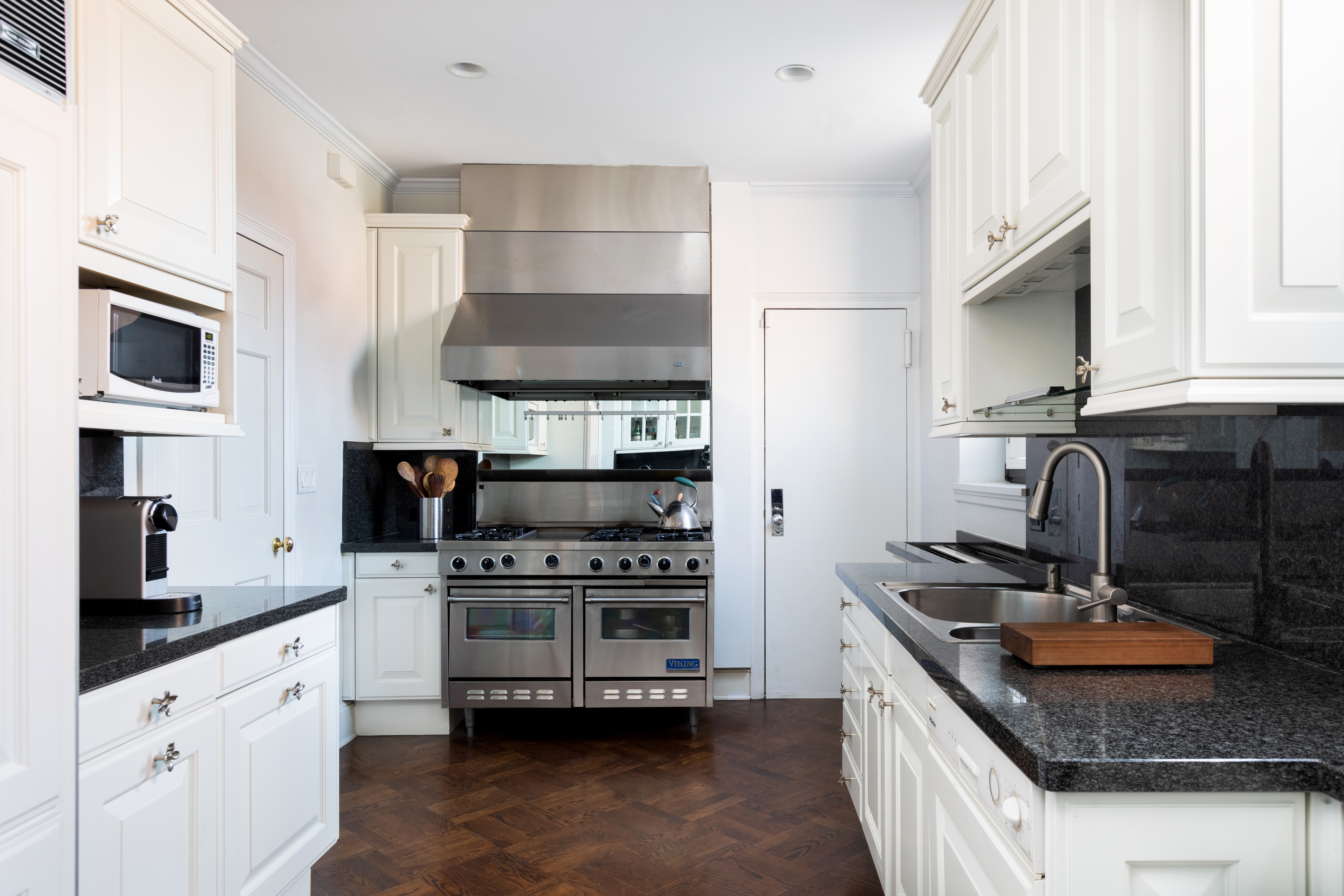 1070 Park Avenue, Unit PHE Manhattan, NY 10128 - Photo 10 of 14 a kitchen with stainless steel appliances a stove a sink and a microwave