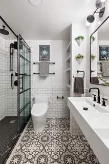 a bathroom with a sink toilet and shower