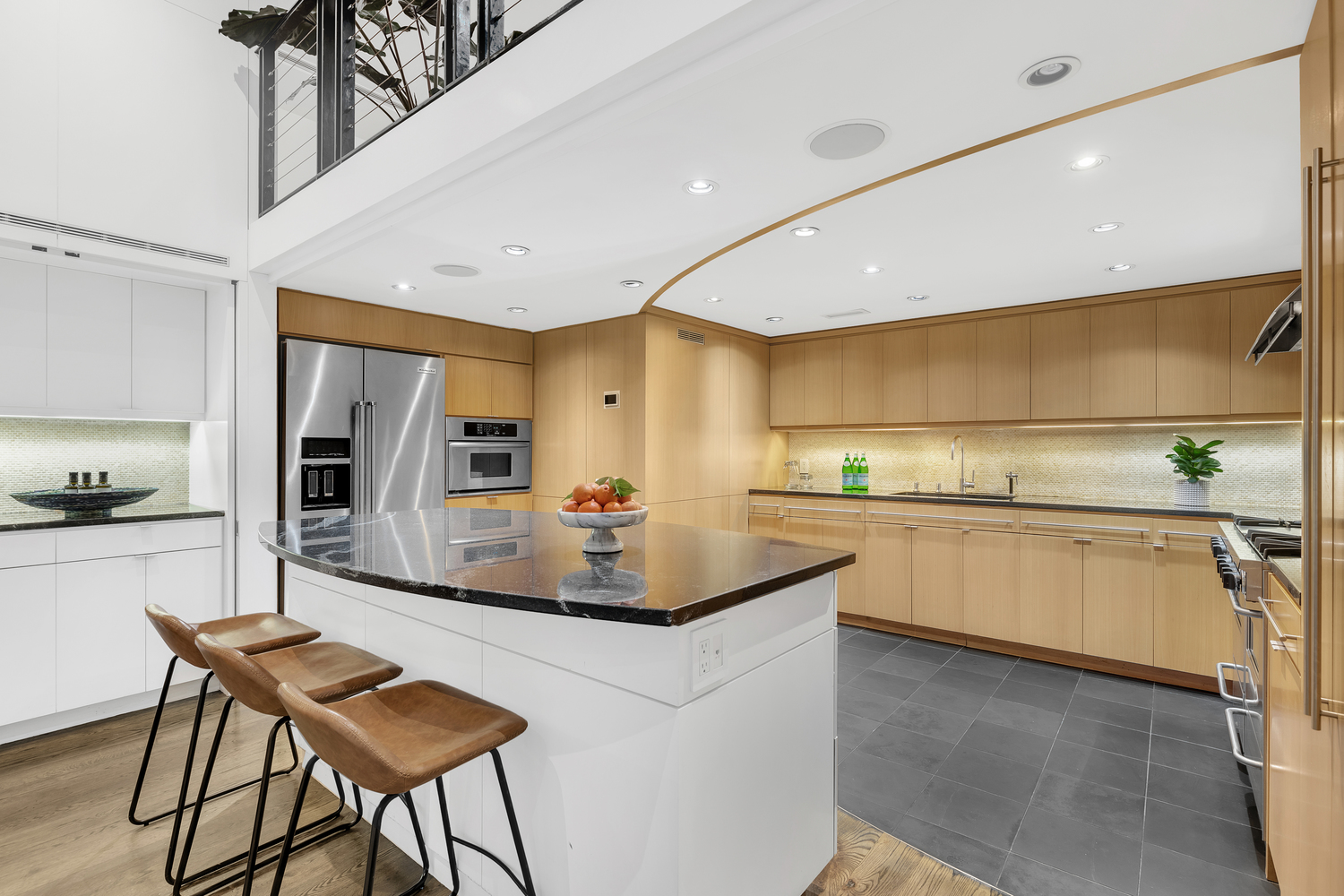 200 Mercer Street, Unit MAIS-G Manhattan, NY 10012 - Photo 6 of 17 a kitchen with stainless steel appliances kitchen island granite countertop a sink and cabinets