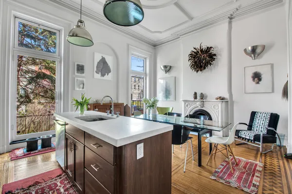 a kitchen with a stove a table and chairs in it