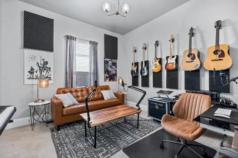 a living room with furniture kitchen view and a window
