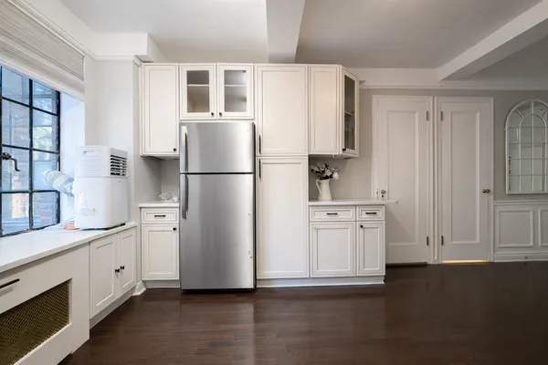 a kitchen with stainless steel appliances a refrigerator sink and cabinets