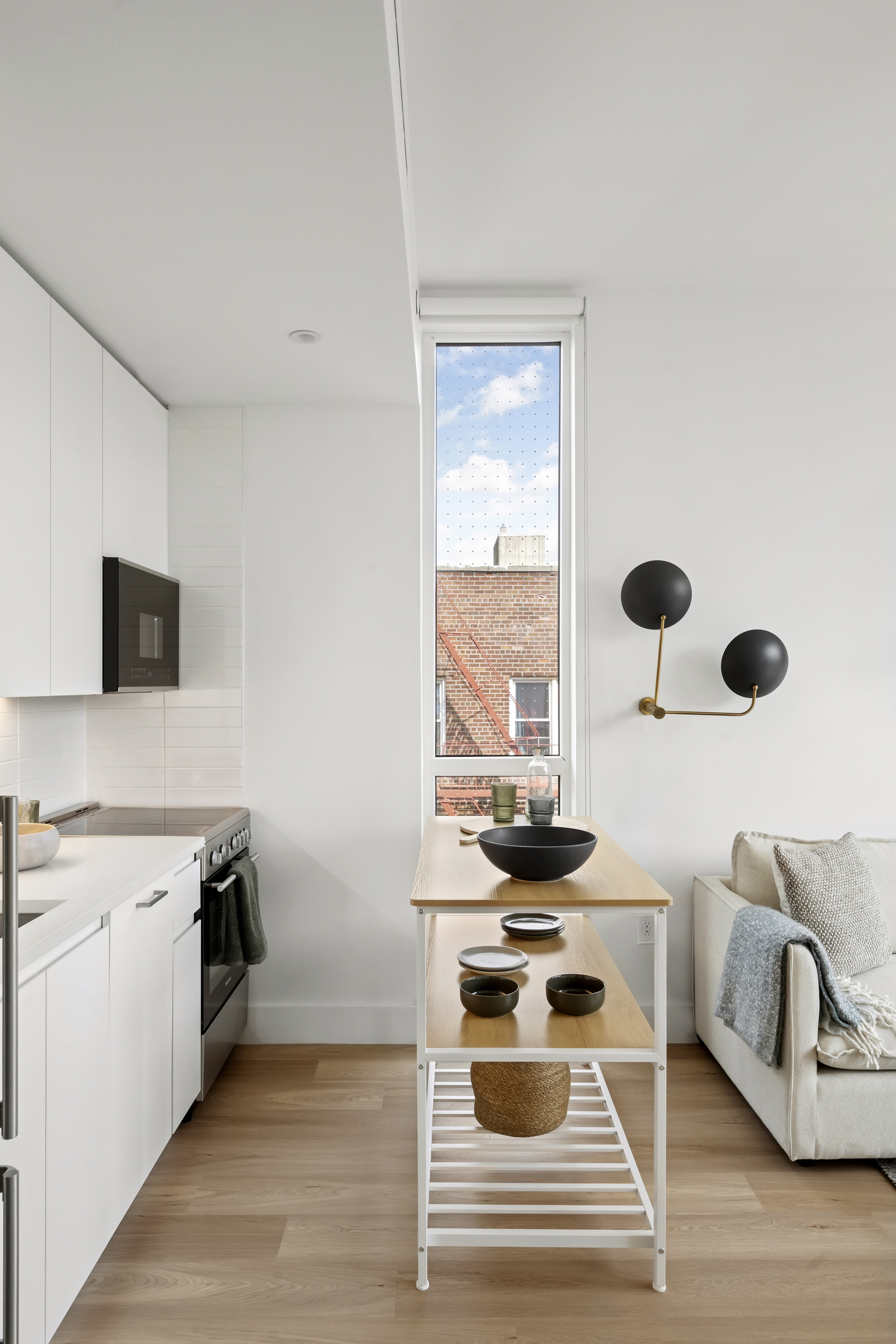 340 Lenox Road, Unit 6D Brooklyn, NY 11226 - Photo 4 of 29 a kitchen with stainless steel appliances kitchen island a stove a sink and a microwave