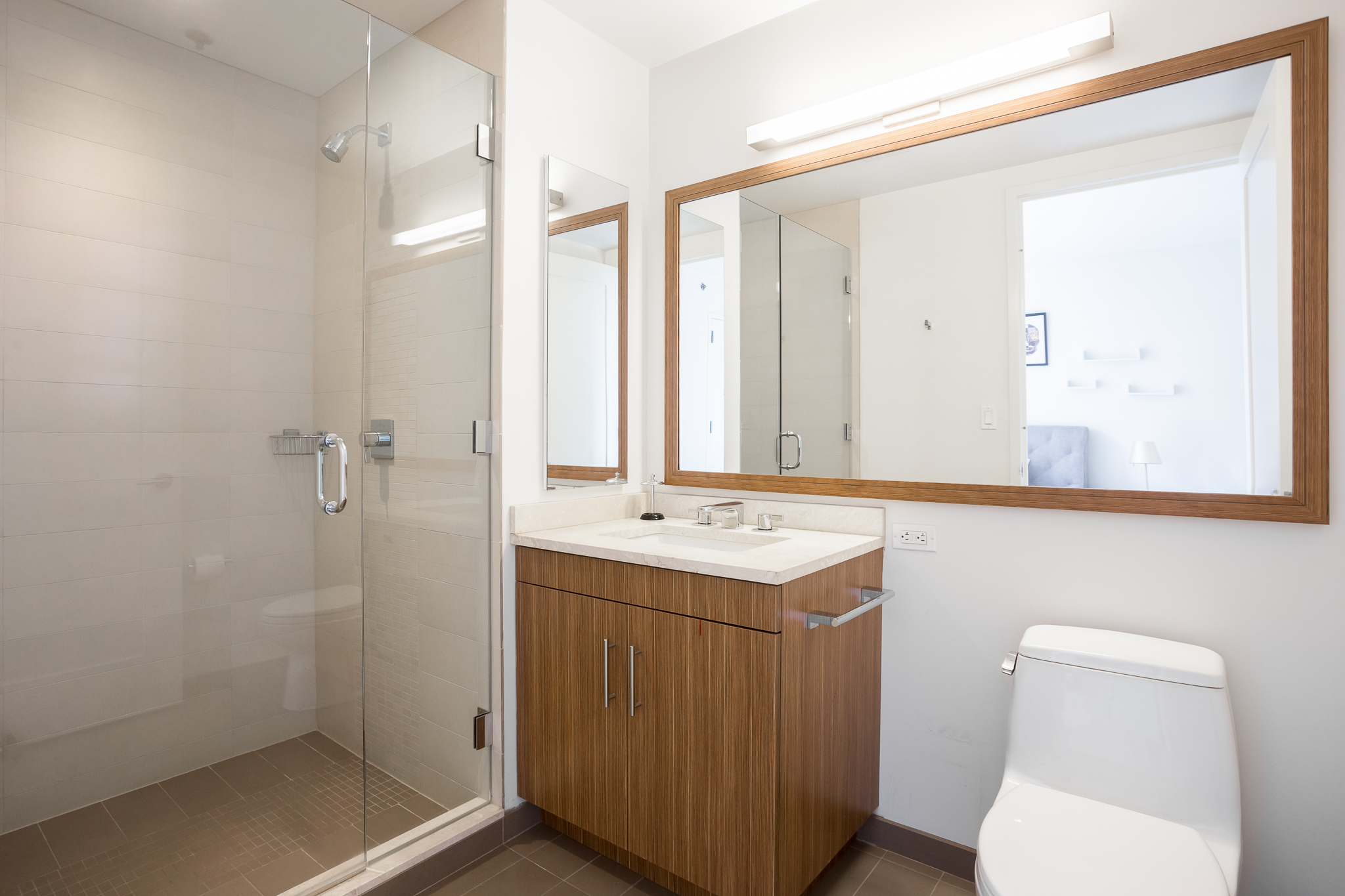 580 Washington Street, Unit 11B Boston, MA 02111 - Photo 9 of 9 a bathroom with a toilet sink and mirror