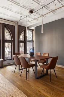 a view of a dining room with furniture wooden floor and a window