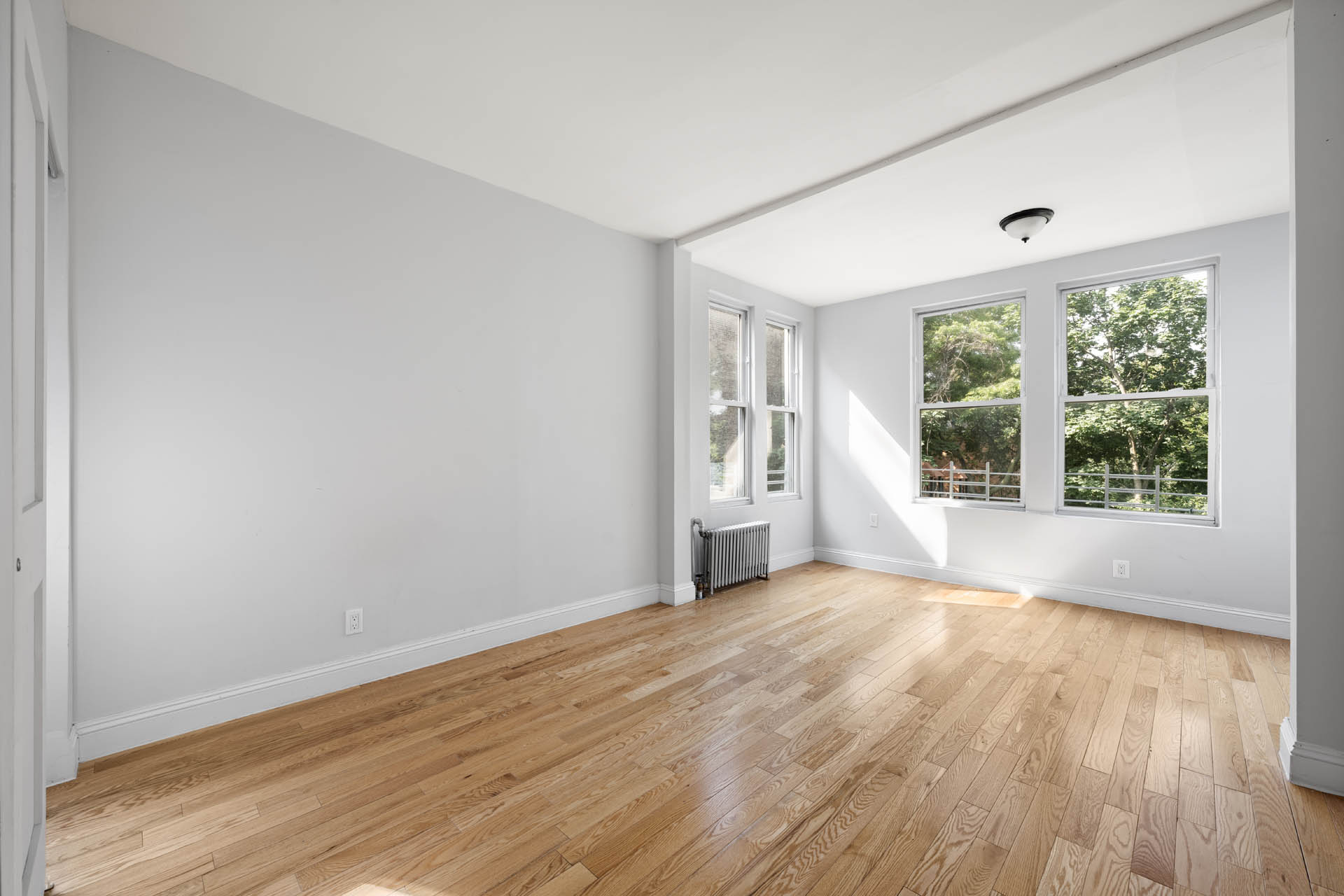 156 Summit Place, Unit 2 Bronx, NY 10463 - Photo 3 of 10 a view of an empty room with wooden floor and a window