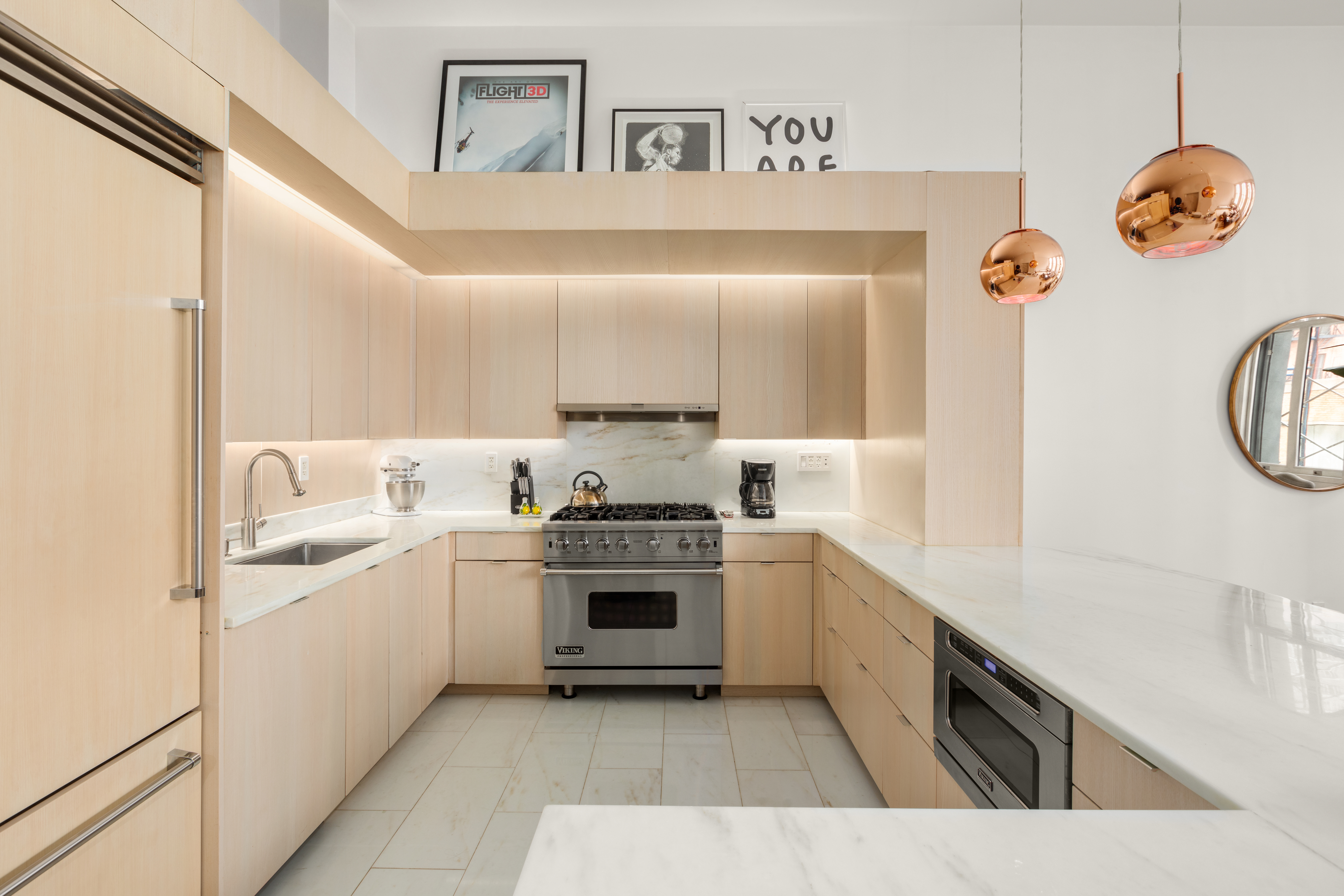 93 Reade Street, Unit 2 Manhattan, NY 10013 - Photo 3 of 9 a kitchen with stainless steel appliances granite countertop a sink and dishwasher a stove top oven with wooden floor