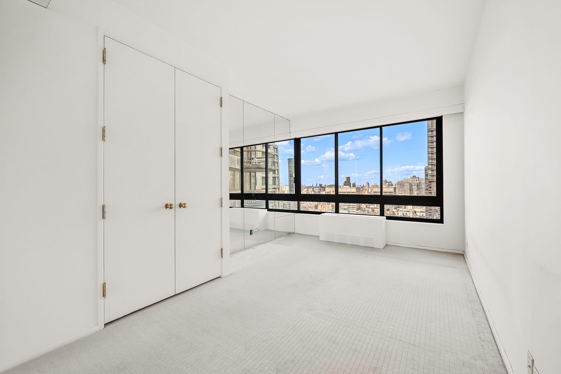 167 East 61st Street, Unit 29C Manhattan, NY 10065 - Photo 9 of 17 a view of an empty room with a window