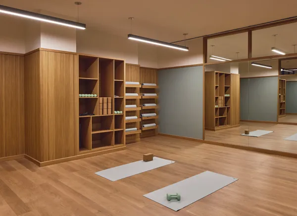 a view of an empty room with closet and wooden floor