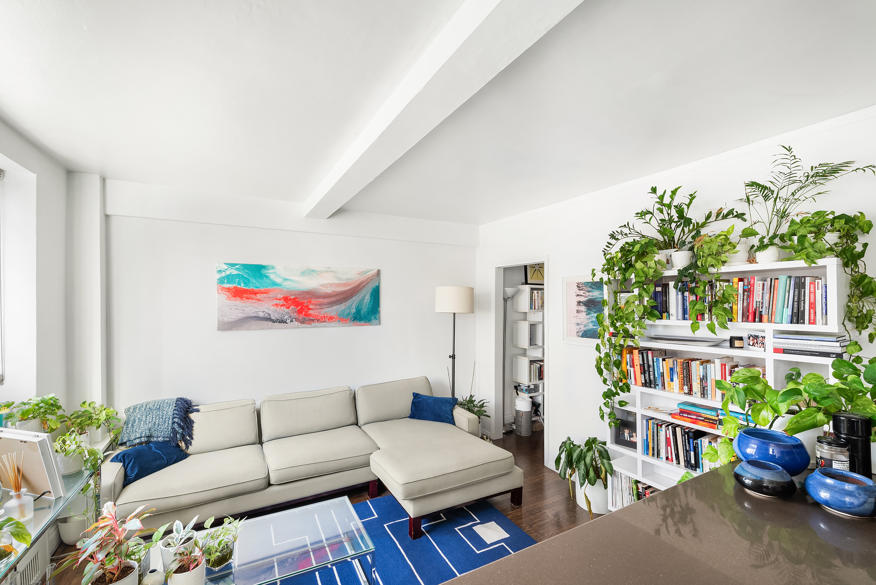 200 West 20th Street, Unit 905 Manhattan, NY 10011 - Photo 4 of 17 a living room with furniture and a potted plant