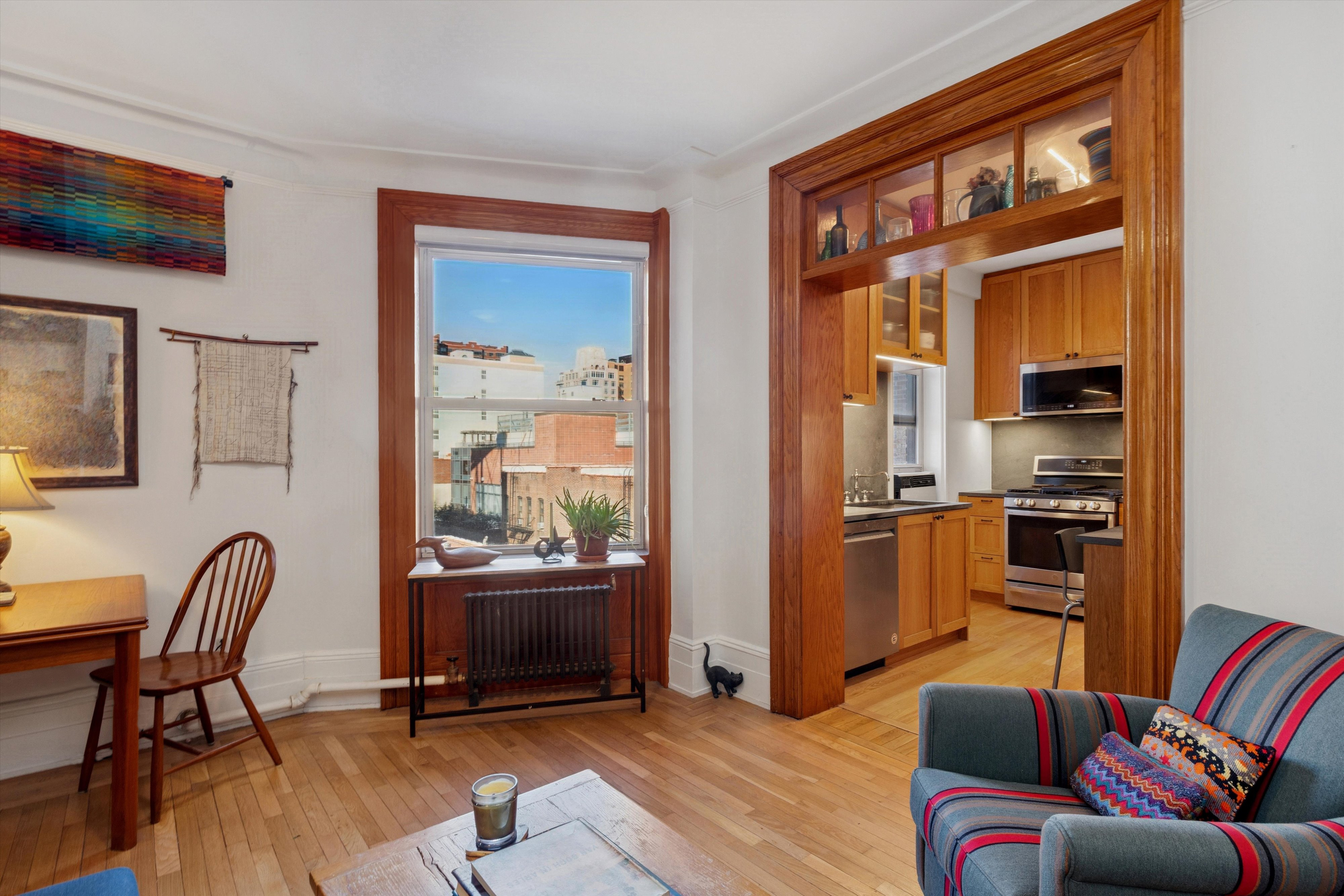 127 West 82nd Street, Unit 8A Manhattan, NY 10024 - Photo 2 of 15 a living room with furniture and a window