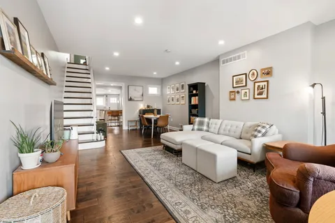 a living room with furniture and wooden floor